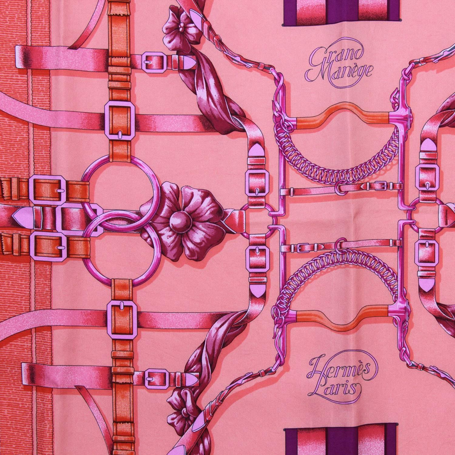 Lively Hermès Hermès "Grand Manège"  silk scarf, borned from the crativity of the designer Henri d'Origny, in a multicolor printed pattern with a mix of bows, ribbons and buckles in shocking pink, fuchsia and red colors. This piece is in