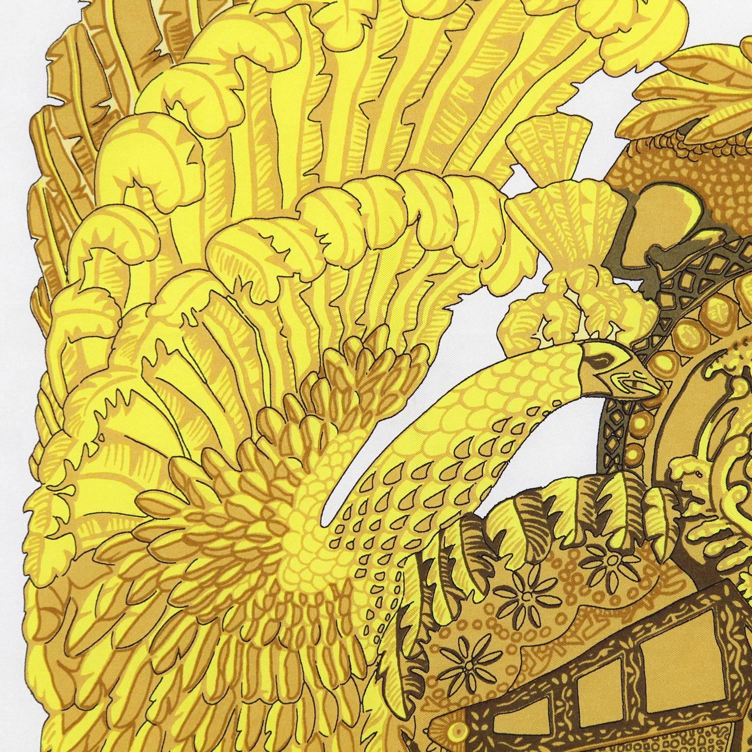 Elegant Hermès Hermès "Armets en Panache" silk scarf, designed by Annie Faivre. The design is a richly ornamented, feathered and jeweled profusion of helmets  in warm tones of gold, tan, and yellow. This piece is in very good conditions.