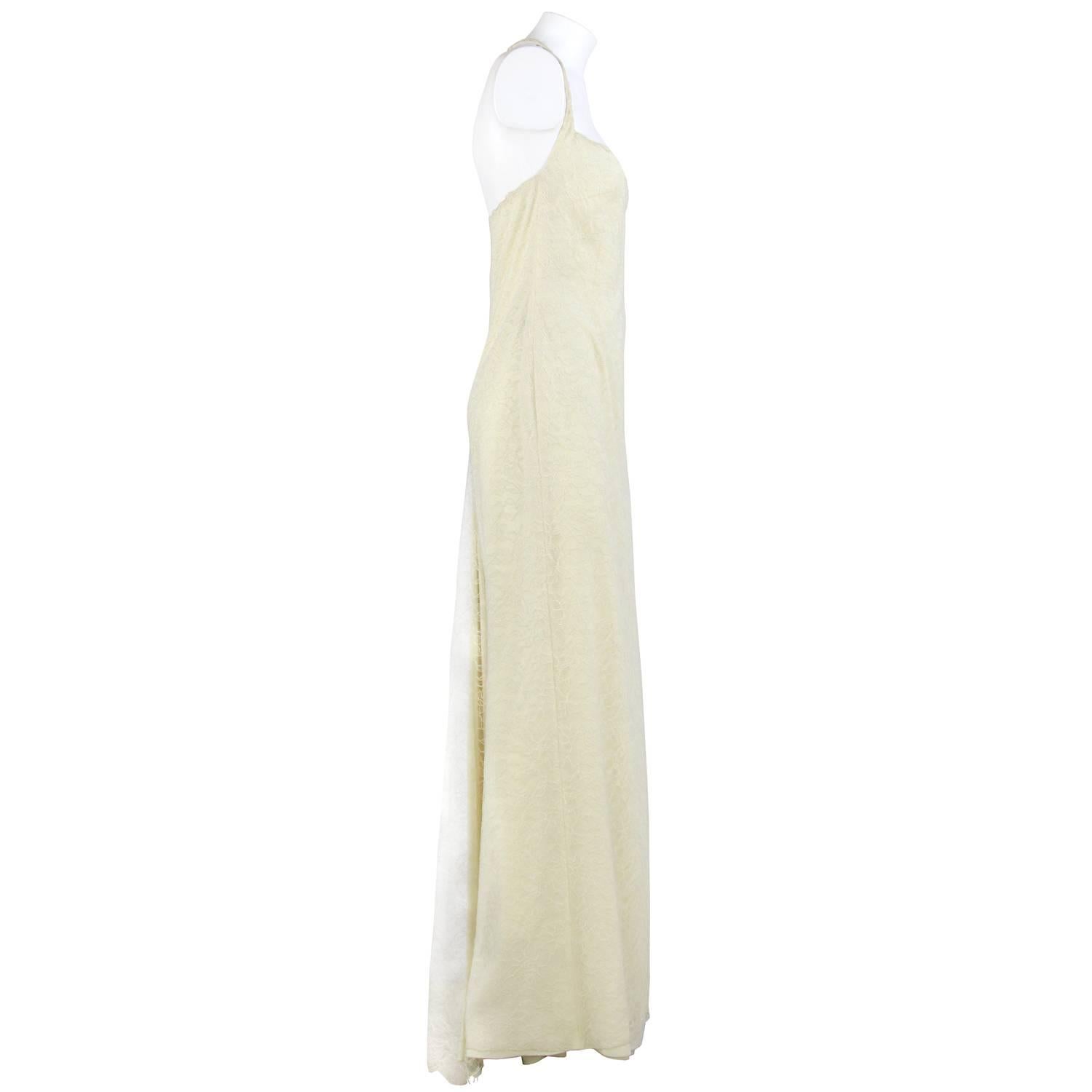Romantic Armani silk wedding dress in ivory color with lace in a floral motif. Thin straps fastened behind the neck with a small plastic pression button, backless. Lateral zip closure. The item was produced in the 2000s and is vintage, is in good