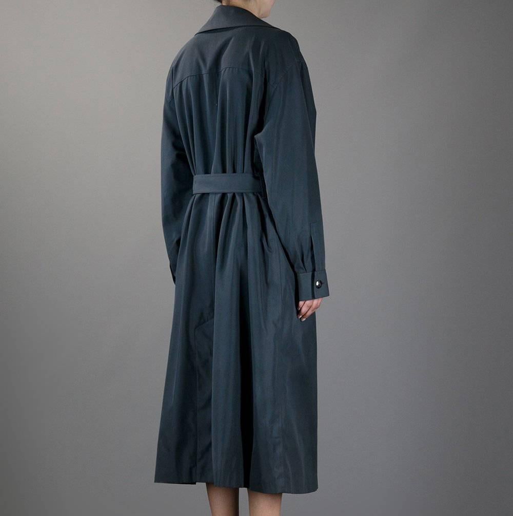 Beautiful smoky grey double-breast trench coat by Chanel. It features a central buttoned closure, a classic belt, two lateral pockets and buttoned cuffs. The item is vintage, it was produced in 1997 and is in excellent conditions. 
Bust: 48