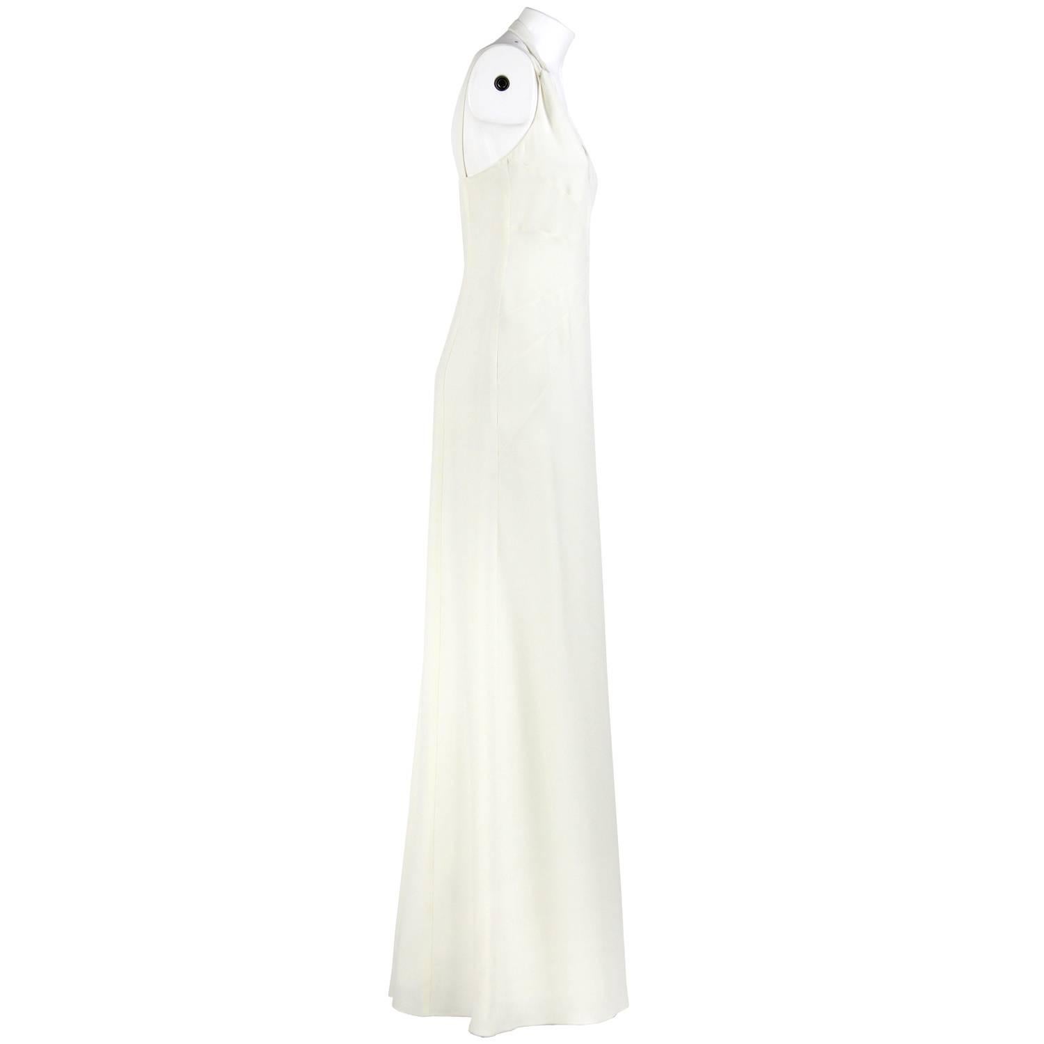 Marvelous Armani silk and acetate wedding dress in milk white color. Thin double straps, one fastened behind the neck . Pretty details on the front and zip closure on the back. The item was produced in the 2000s and is vintage, is in excellent