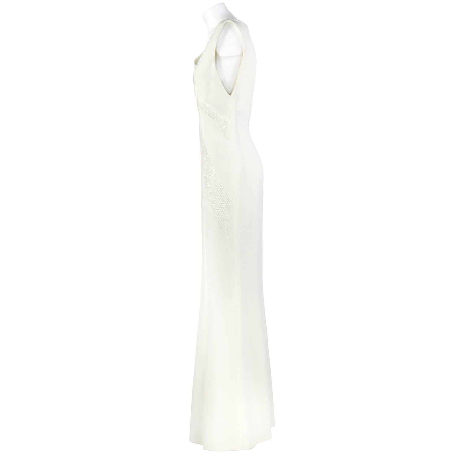 Marvelous Gianni Versace wedding dress, Versatile line, in white milk color. It features a splendid beads decoration on the front. Zip closure on the back. The item is vintage, it was produced in the 2000s and is in excellent conditions. It comes