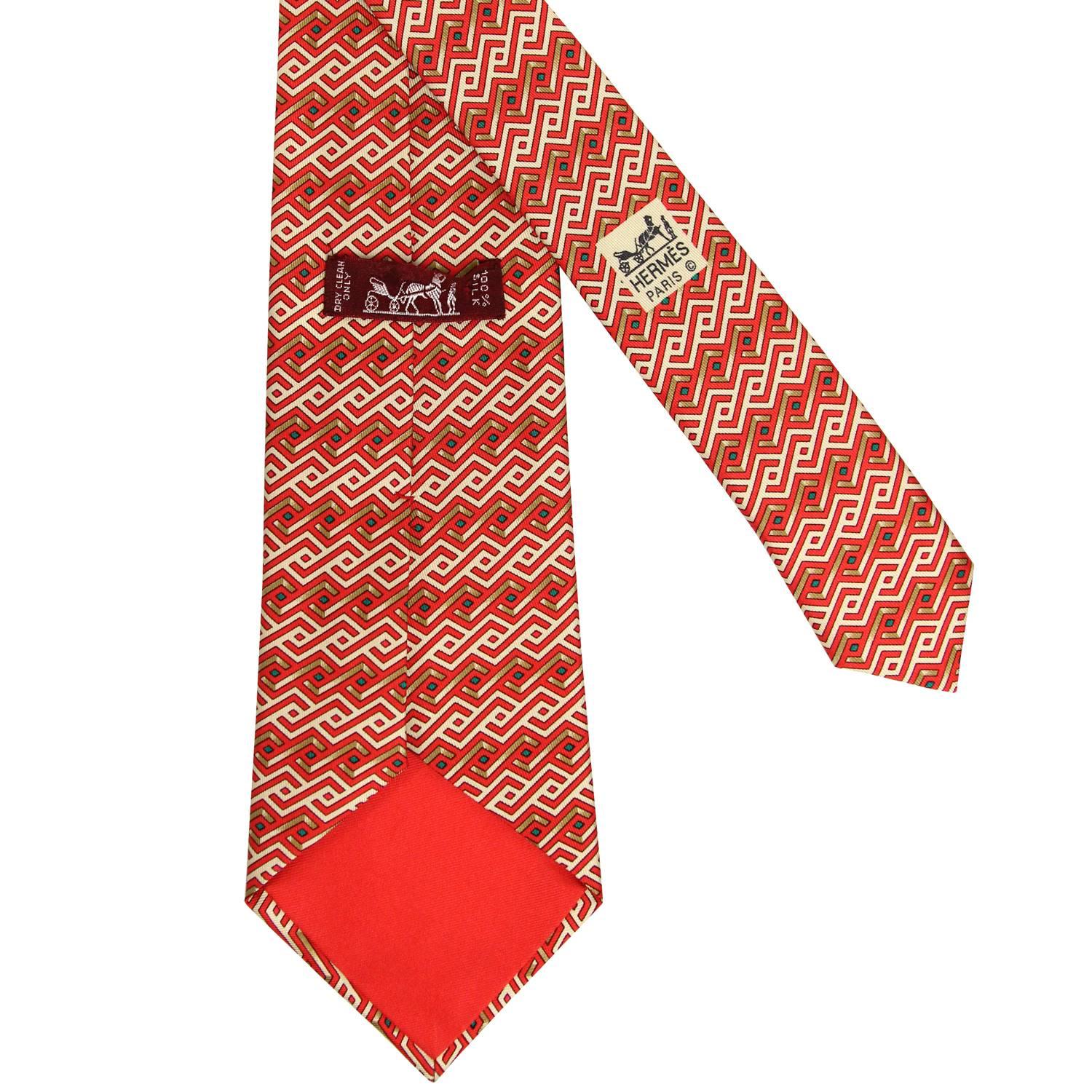 Lively Hermès 100% printed silk tie with a geometric pattern of red, beige and green color. The item is vintage and is in excellent conditions, flawless.  Width: 9
