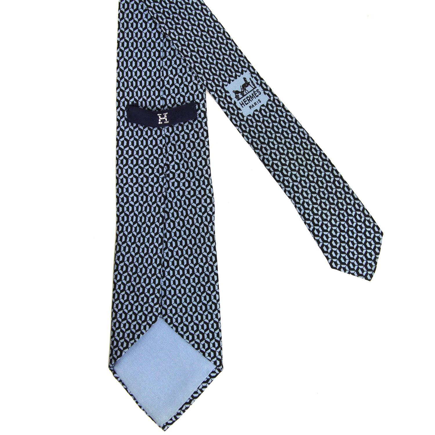 Beautiful Hermès 100% silk printed tie with a black and light blue silk hexagon pattern. The item is vintage, it was produced in the 60s and is in excellent conditions, flawless.  Width: 7

