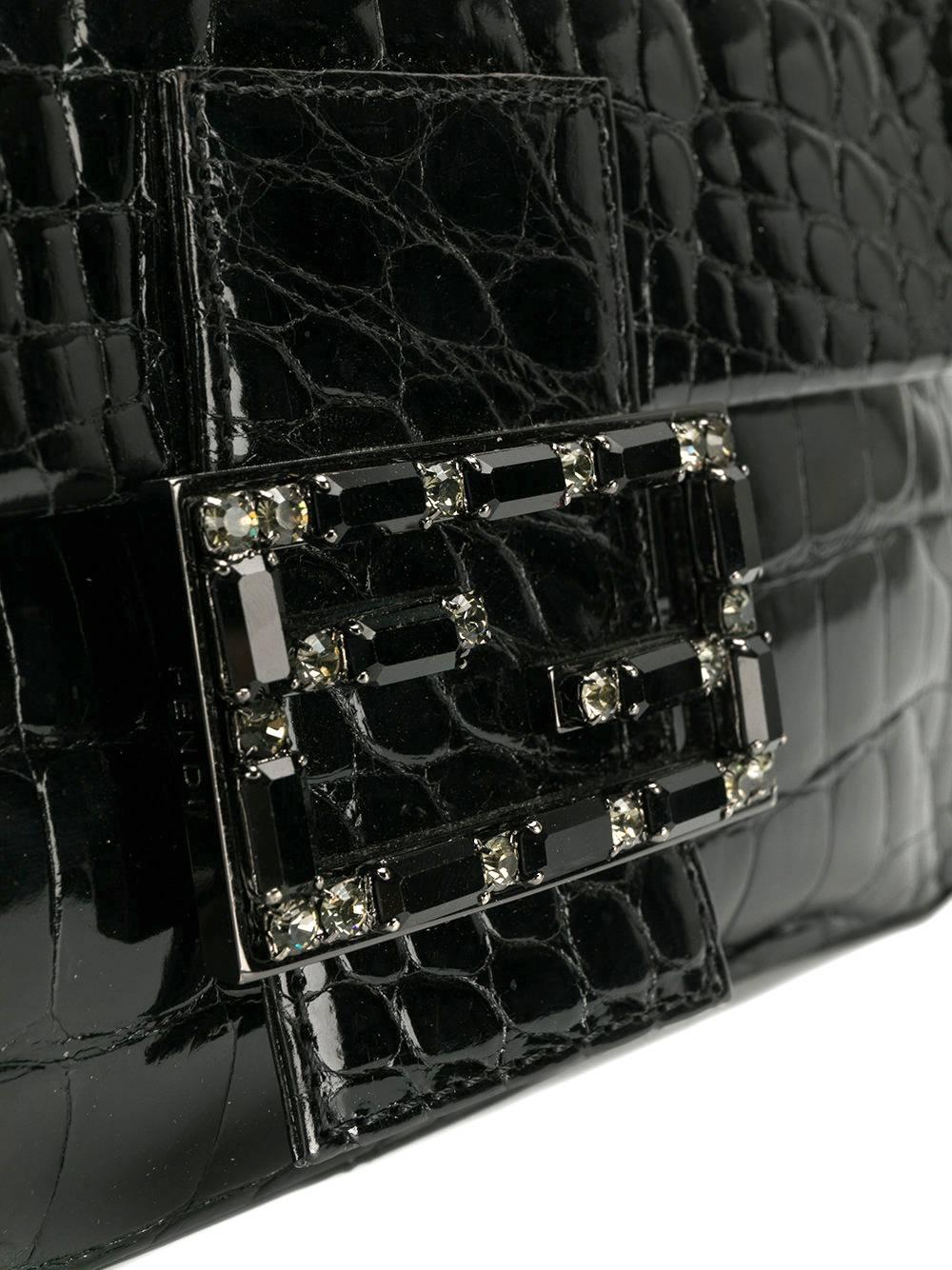 Elegant Fendi black crocodile leather baguette bag. If features a magnetic button closure, embellished with rhinestone double-logo plaque. The bag comes with its original dustbag. The item is vintage, it was produced in the 2000s and is in excellent