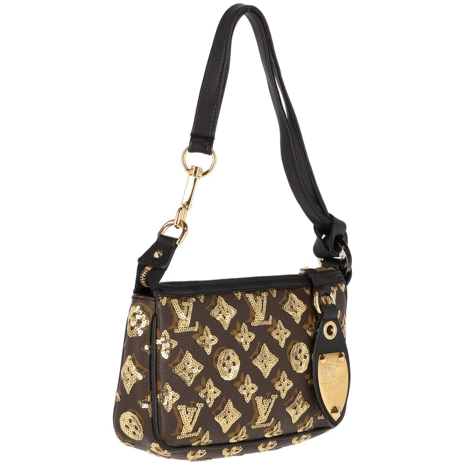 Louis Vuitton vintage monogram sequined and leather clutch. Features golden hardware and sequins and closes with a zip. Black leather handle. Very good conditions.