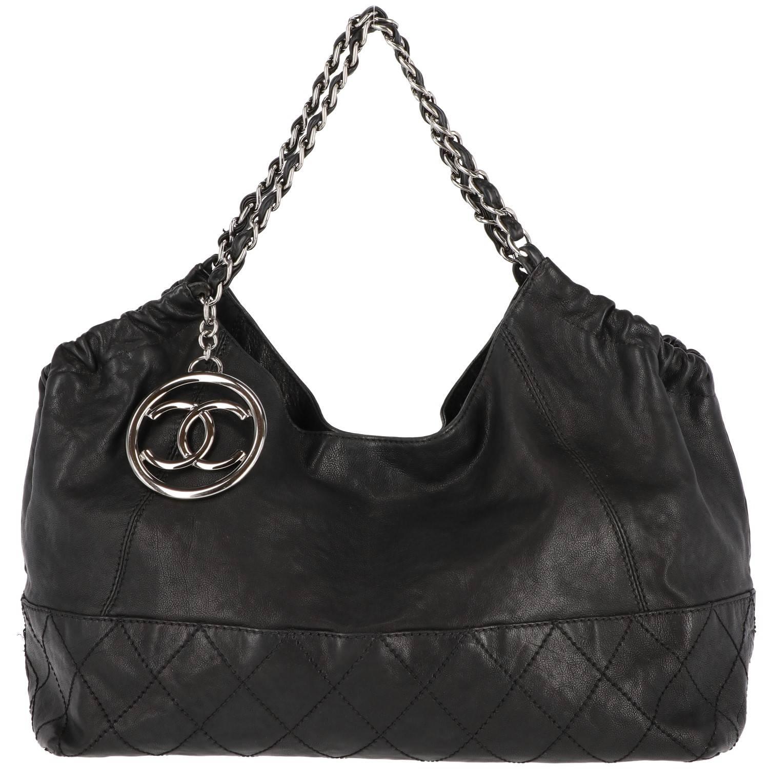 Vintage Chanel Coco Cabas tote bag in soft black leather with quilted stitches and metal charm in the classic double C shape from the French Maison. Features a chain and black leather shoulder strap.