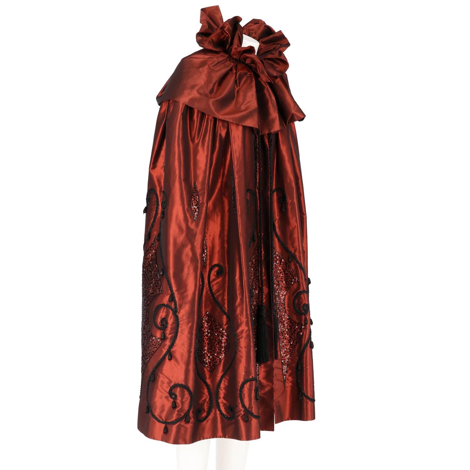 Spectacular Guy Laroche cape from the 1990s. This magnificent piece is made of irridescent copper taffeta. Features inside lining, precious sequined embroidery, beads and cords.

One size