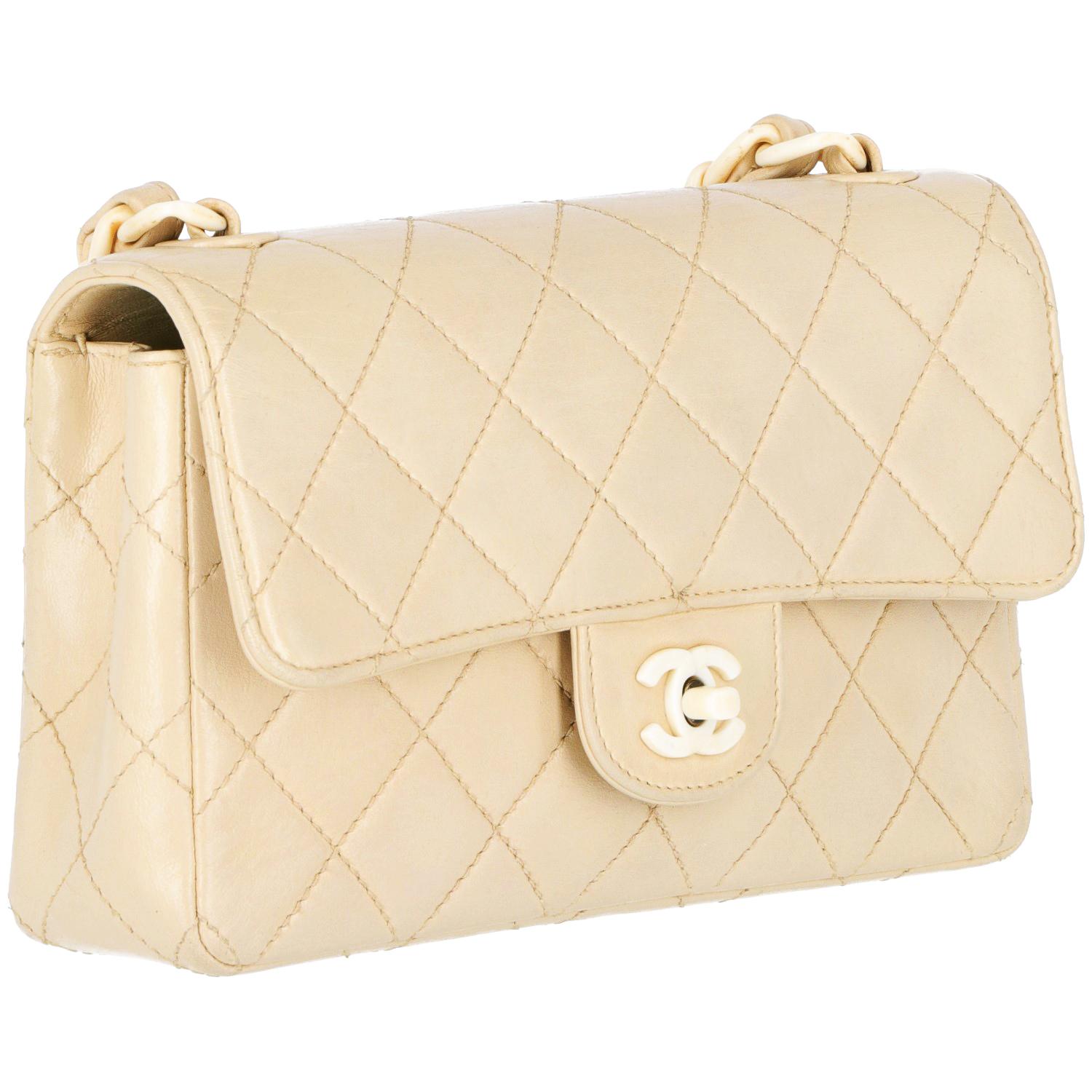 The Chanel matelassé leather bag is from 1997-1999 Chanel collection. With ivory chain and braided leather shoulder strap, front logo ivory pvc plaque and clasp fastening. The authenticity card is included. The bag is vintage: it shows different