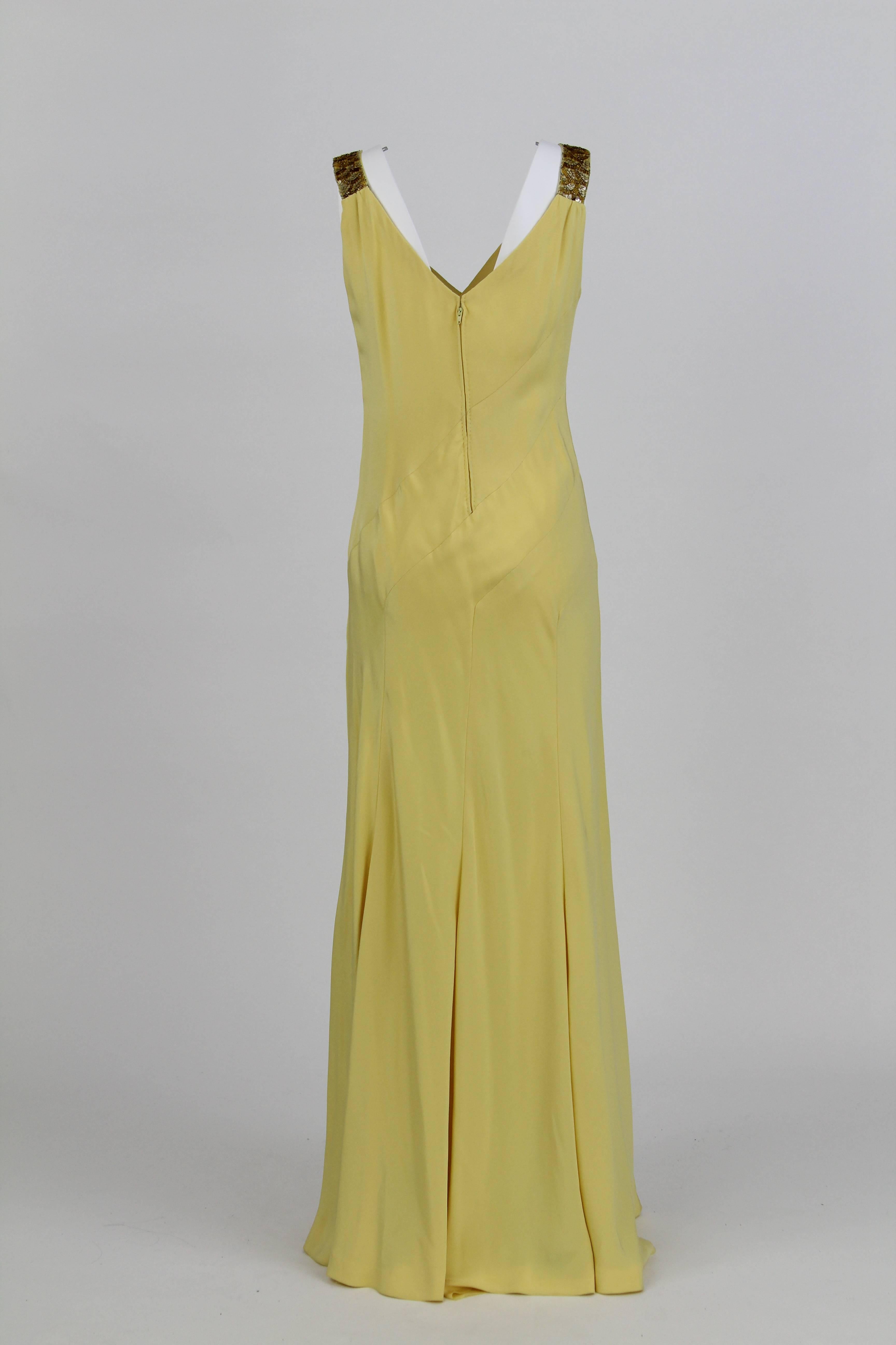 Flattering yellow dress handmade in Italy by the tailoring house Stop Sénès, featuring a V-neck, sequin embellished straps and a back zipper. 
In good conditions.
The dress is size 42. 
Considering the straps, the dress is 150 cm.