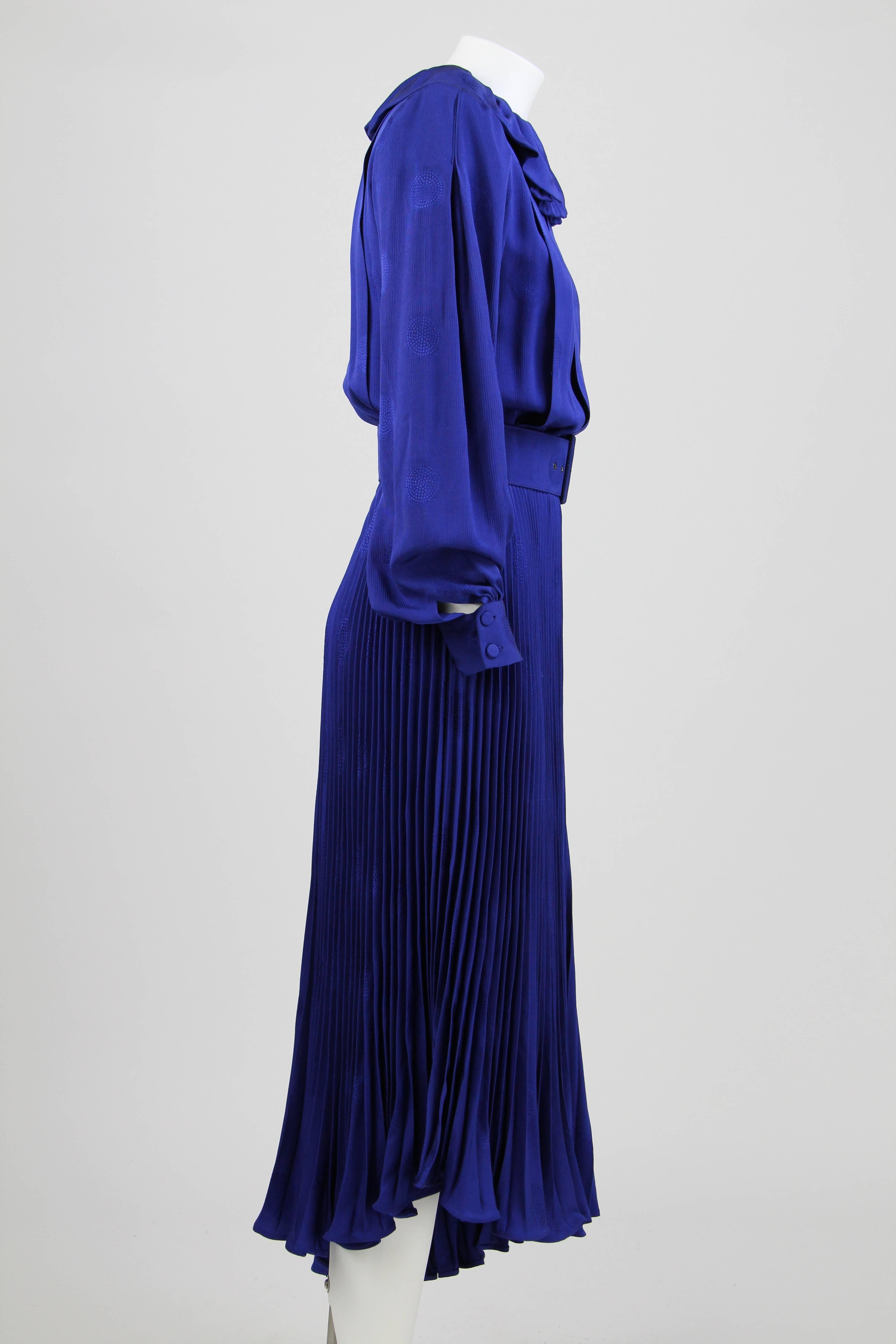 Early 1980s André Laug Blue Silk Draped Dress featuring a wide collar, an asymmetric and plissé skirt and buttoned cuffs. 
This item was designed and made in Italy by the French designer André Laug. It is kept in very good conditions.
Size 40 IT.