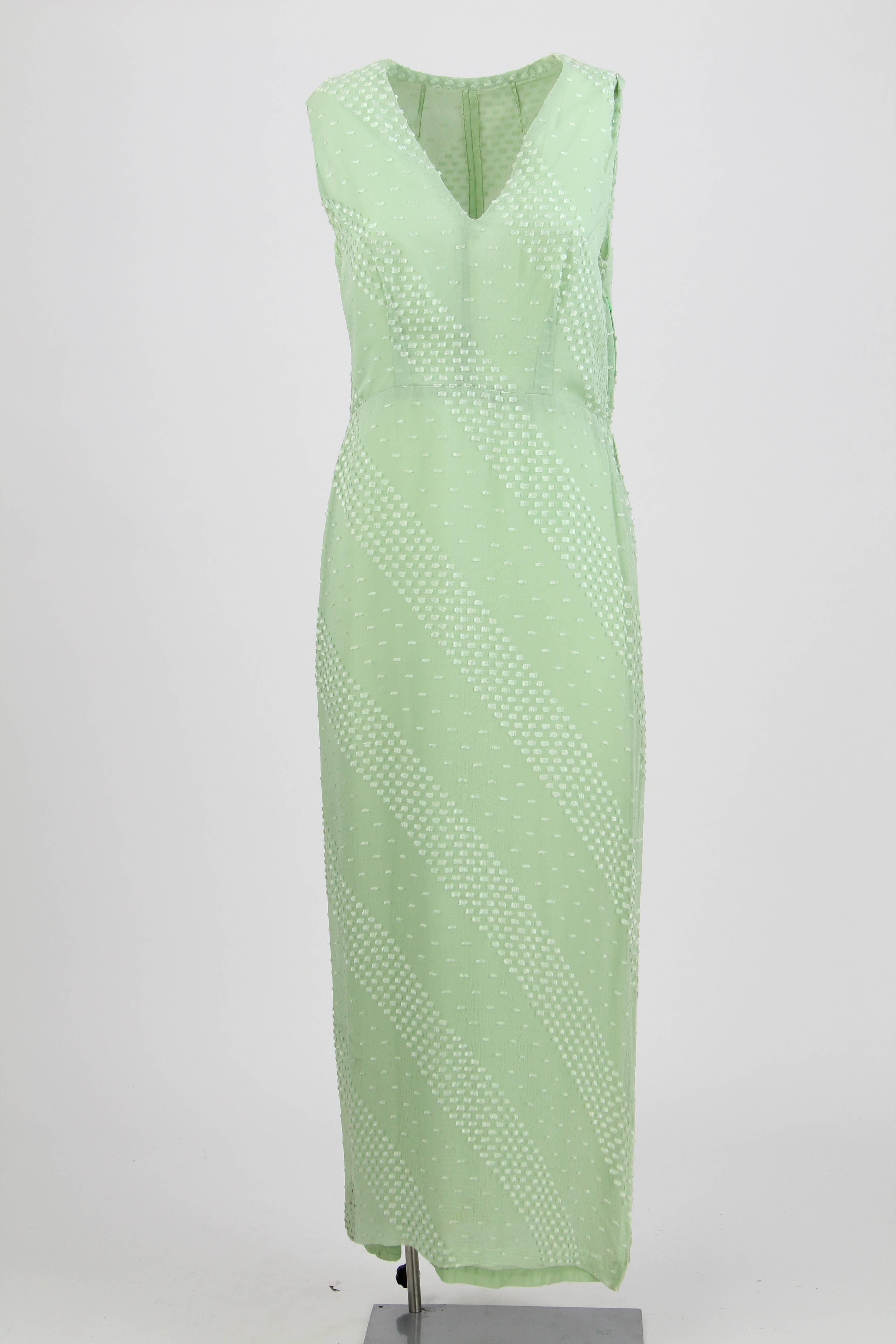 Ethereal tailored sleeveless silk dress in mint green color with V neckline and a characteristic embroidery. It features a regular waist, and comes with a sleeved jacket in the same fabric trimmed with mint green feathers. The dress has a zip on one