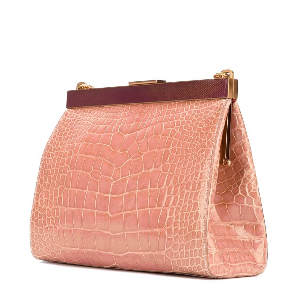 Fabulous Prada crocodile leather small handbag in peach pink color with purple detail. It features a chain strap, a top magnetic closure and an internal zipped pocket. The item is vintage, it was produced in the 2000s and is in very good conditions,