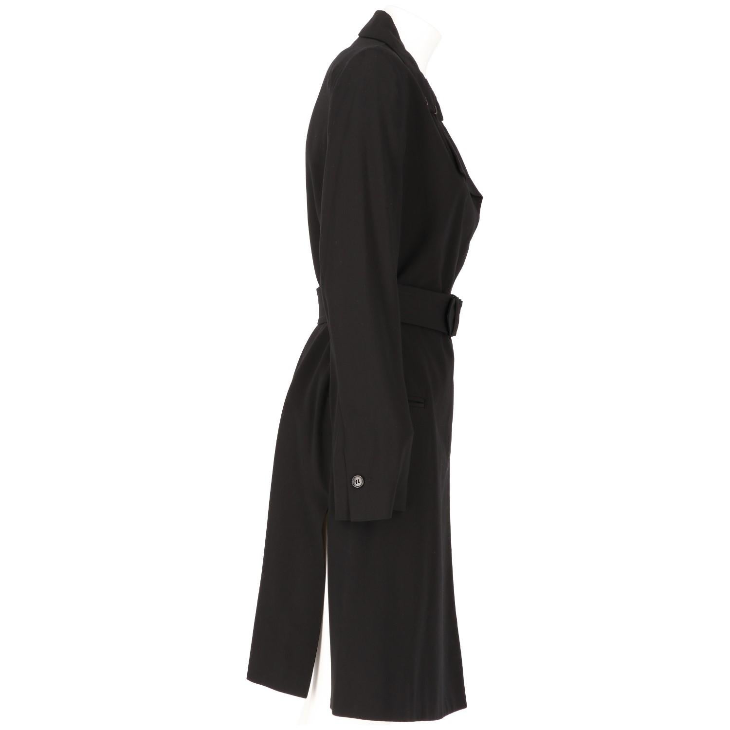 Ann Demeulemeester minimal blend wool black overcoat. Lightly padded shoulders, classic neckline with revers, hidden buttons fastenings on the front, adjustable belt, two frontal pockets. The item is vintage, it was produced in the 2000s and is in