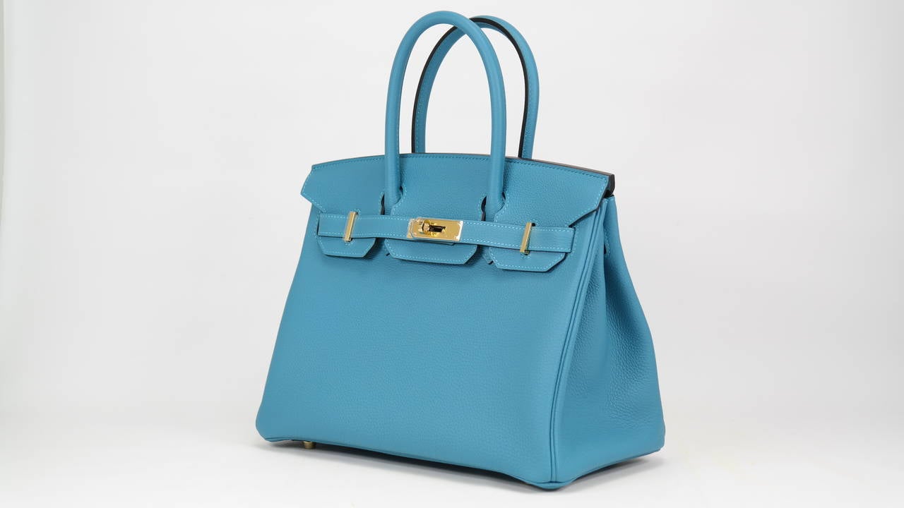 HERMES Birkin Bag 30cm Tourquoise Veau Togo Gold Hardware
with the protective plastic intact.
Comes with original box, dustbag, clochette, lock, two keys, felt, rain cover, clochette dustbag, and care booklet.
*Protective felt removed for