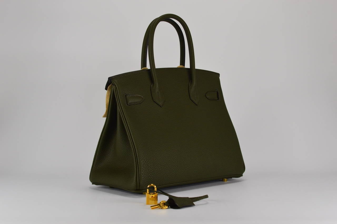 HERMES Handbag BIRKIN 30 TOGO VERT OLIVE GOLD HARDWARE
with the protective plastic intact.
Comes with original box, dustbag, clochette, lock, two keys, felt, rain cover, clochette dustbag, and care booklet.
*Protective felt removed for purposes