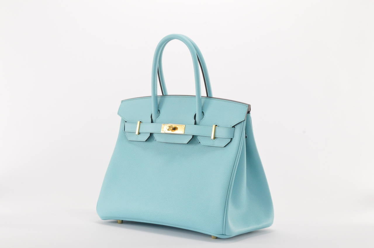 HERMES Handbag BIRKIN 30 EPSOM  Blue ATOLL GOLD HARDWARE
with the protective plastic intact.
Comes with original box, dustbag, clochette, lock, two keys, felt, rain cover, clochette dustbag, and care booklet.
*Protective felt removed for purposes