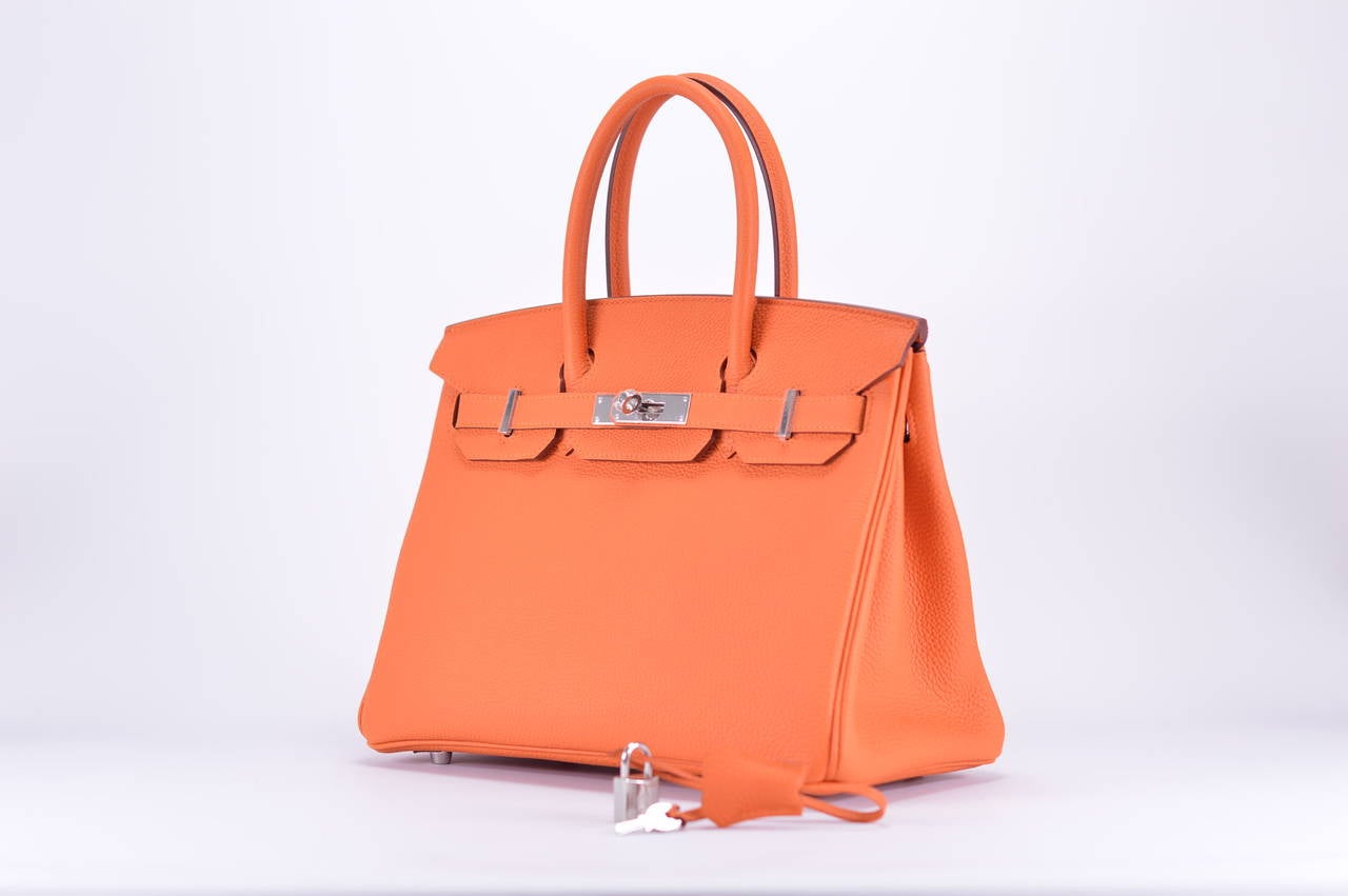 HERMES Handbag BIRKIN 30 TOGO ORANGE COLOR PALLADIUM HARDWARE.

Model: BIRKIN

Dimension: 30cm width x 22cm height x 16cm length

Color:  ORANG

Pre-owned and never used

Details:

With the protective plastic intact.

Comes with