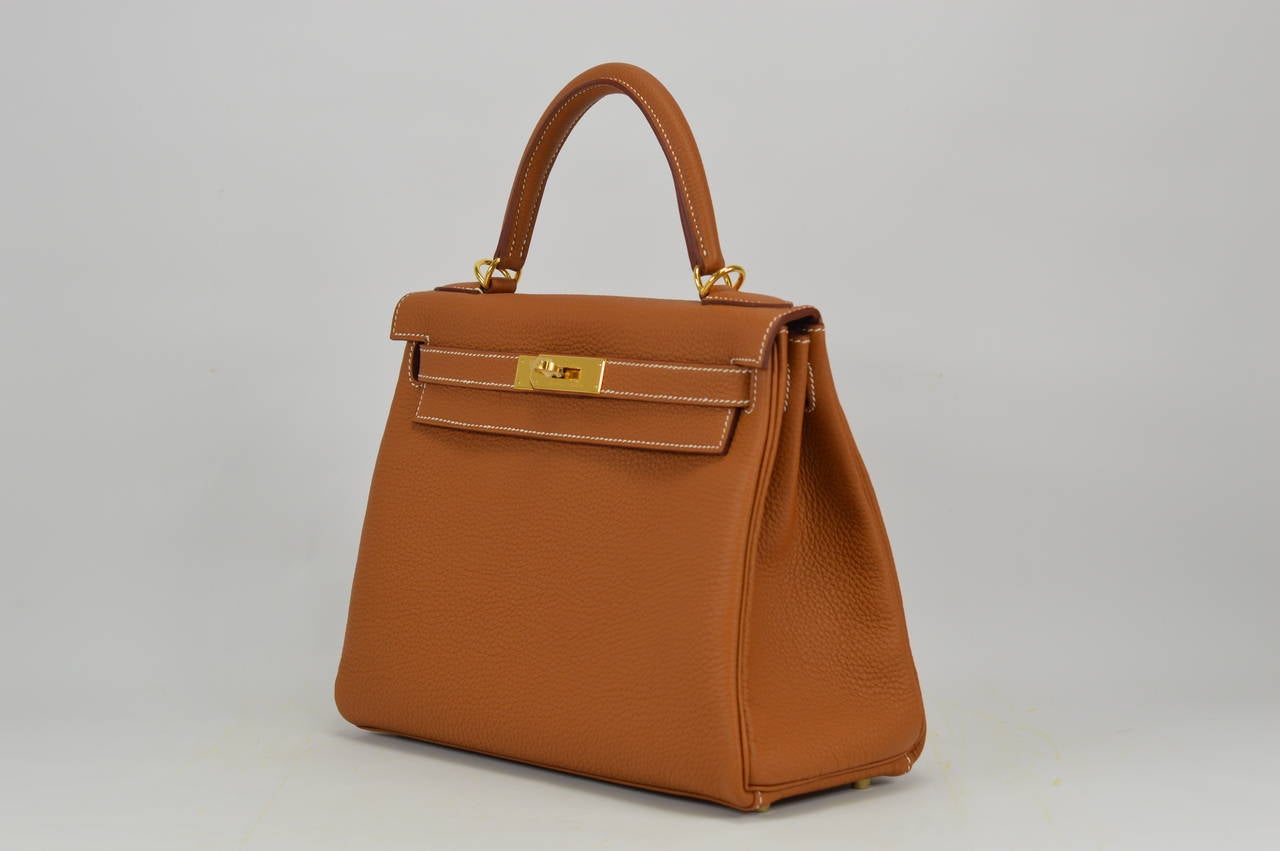 2014 Hermes Kelly Bag II Retourne  28cm Gold color Gold Hardware Veau Togo
Stamp R.
Hardware with protective plastic intact.
Comes with original box, dustbag, clochette, lock, two keys, clochette dustbag, shoulder strap, shoulder strap dustbag,