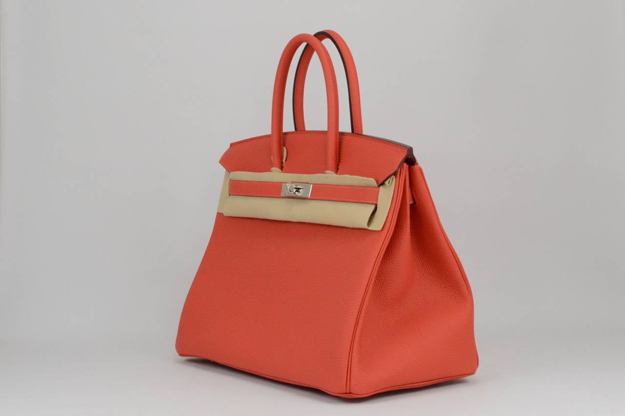 2014 Hermes Birkin Bag 35 Rouge Pivoine Togo Leather Palladium Hardware with the protective plastic intact.
Comes with original box, dustbag, clochette, lock, two keys, felt, rain cover, clochette dustbag, and care booklet.
*Protective felt