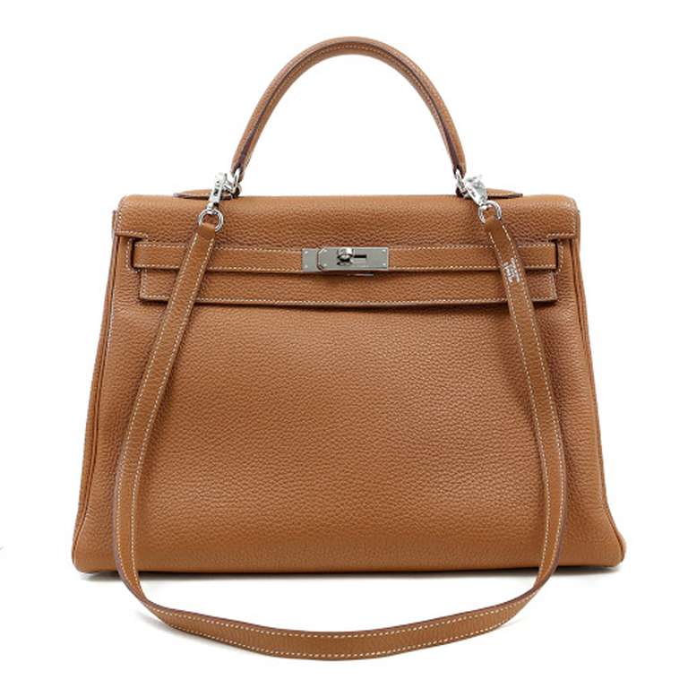 Hermes Gold Kelly with Palladium  35 cm

The sophisticated Kelly style is always in high demand; it is particularly coveted in the year round neutral classic Gold with Palladium hardware.
 
Scratch resistant Togo calf leather; textured with a