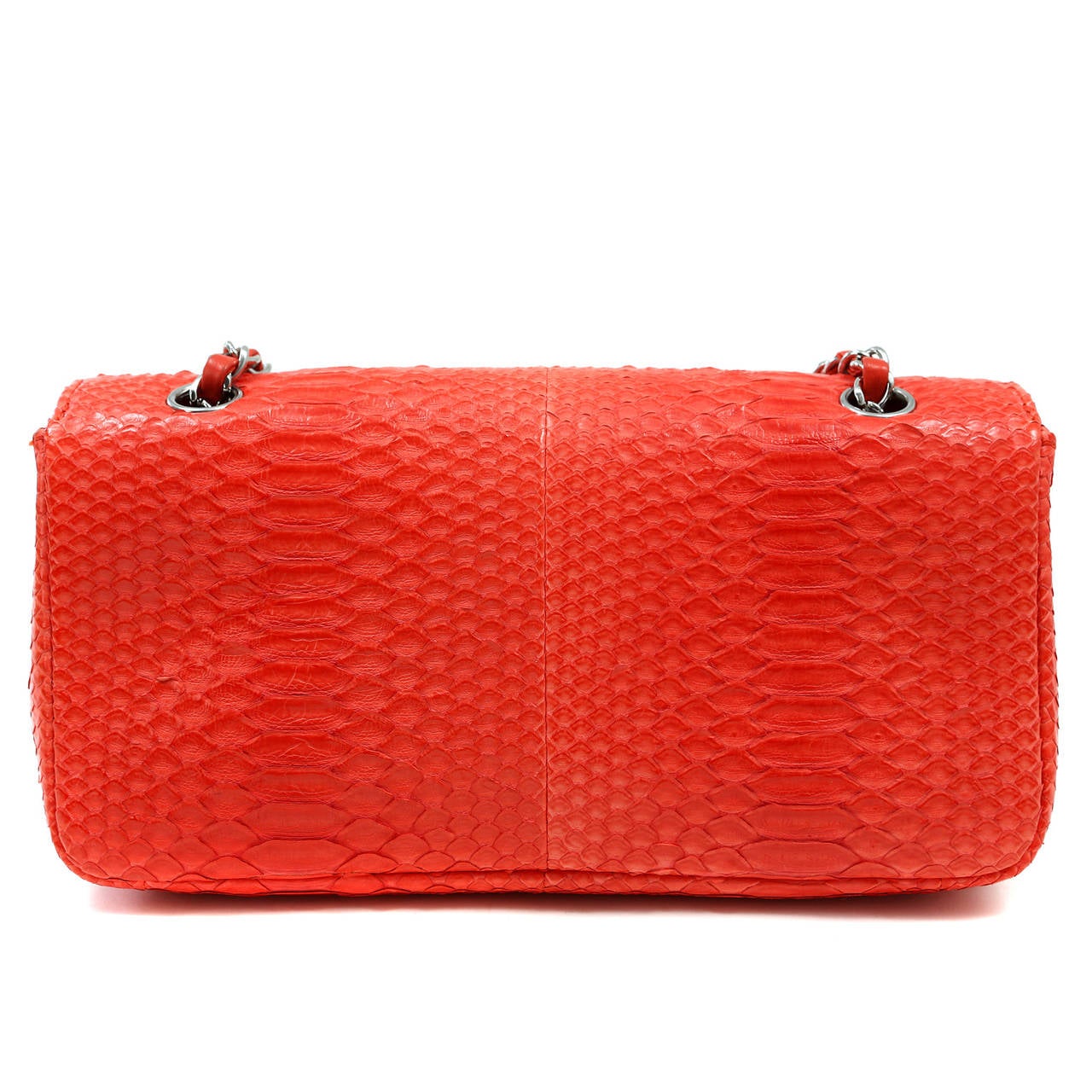 Chanel Coral Python Classic Flap Bag

Pristine condition, medium size, silver hardware.  A collectible exotic Chanel in fiery coral.
 
Bright coral python skin flap bag has silver interlocking CC twist lock securing the front flap.  Coordinating