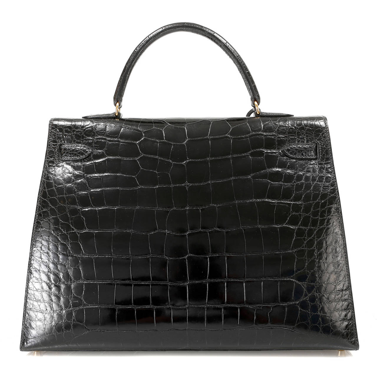 Hermès 35 cm Black Alligator Kelly 
Nearly pristine condition; rarely carried.   Hermès bags are considered the ultimate luxury item worldwide.  Each piece is handcrafted with waitlists that can exceed a year or more.  Extremely rare in Black