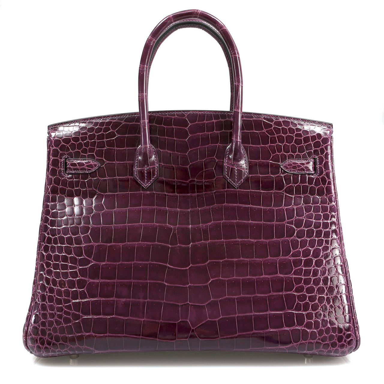 Hermès Cassis Shiny Porosus Crocodile 35cm Birkin has never been carried and remains totally pristine.  Incredibly rare and specially ordered, this exotic Birkin is truly stunning in jewel toned purple croc with Palladium hardware. 
 
Hermès