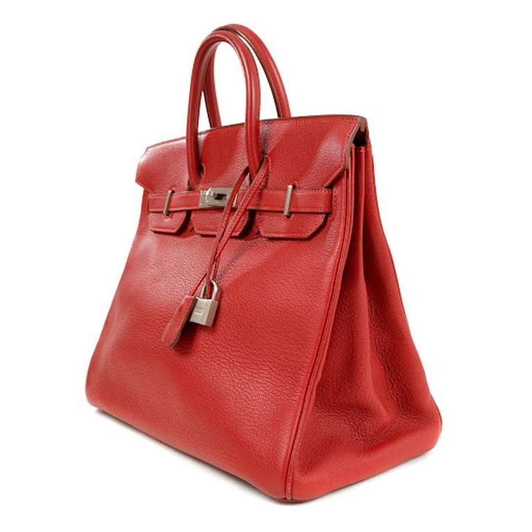 A chic, Limited Edition Hermès Birkin HAC 32 CM in vivid red Clemence leather. This beautiful, classic handbag features palladium hardware. Includes original lock, keys, and clochette. Dimensions: 13