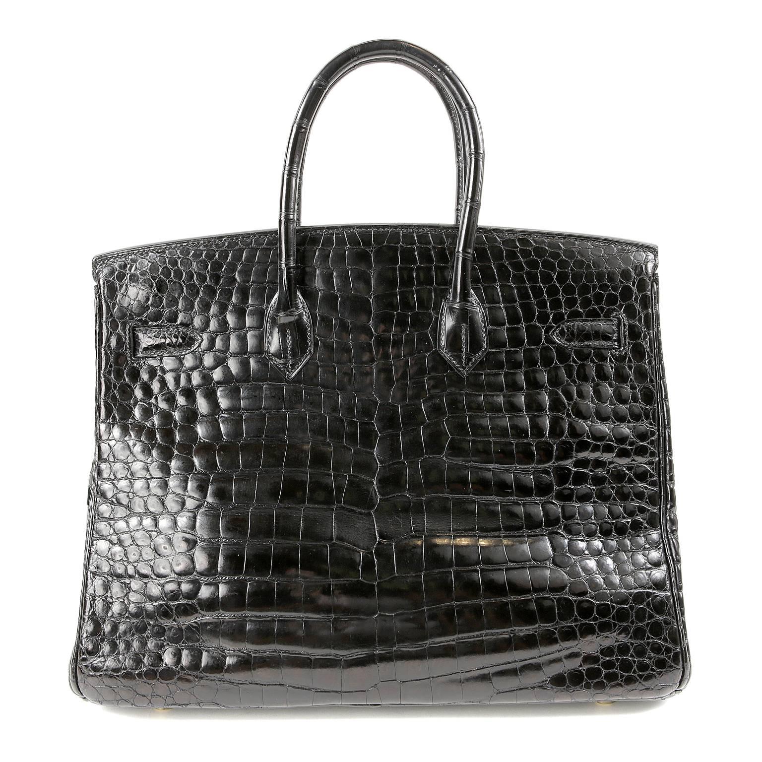 Hermès Black Shiny Porosus Crocodile 35cm Birkin - nearly pristine condition.   Incredibly rare and specially ordered, this exotic Birkin is truly stunning in sleek black croc with gold hardware. 
 Hermès bags are considered the ultimate luxury