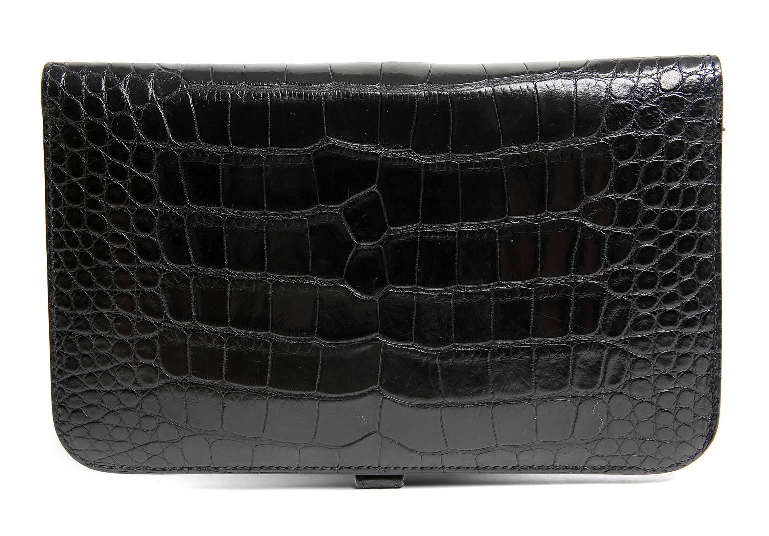 Hermès Black Alligator Dogon Combined Wallet- PRISTINE unworn condition.  The classic style easily organizes all the currency, coins and cards necessary to navigate a busy lifestyle. 
 Alligator, indicated by the square symbol stamp, is one of the