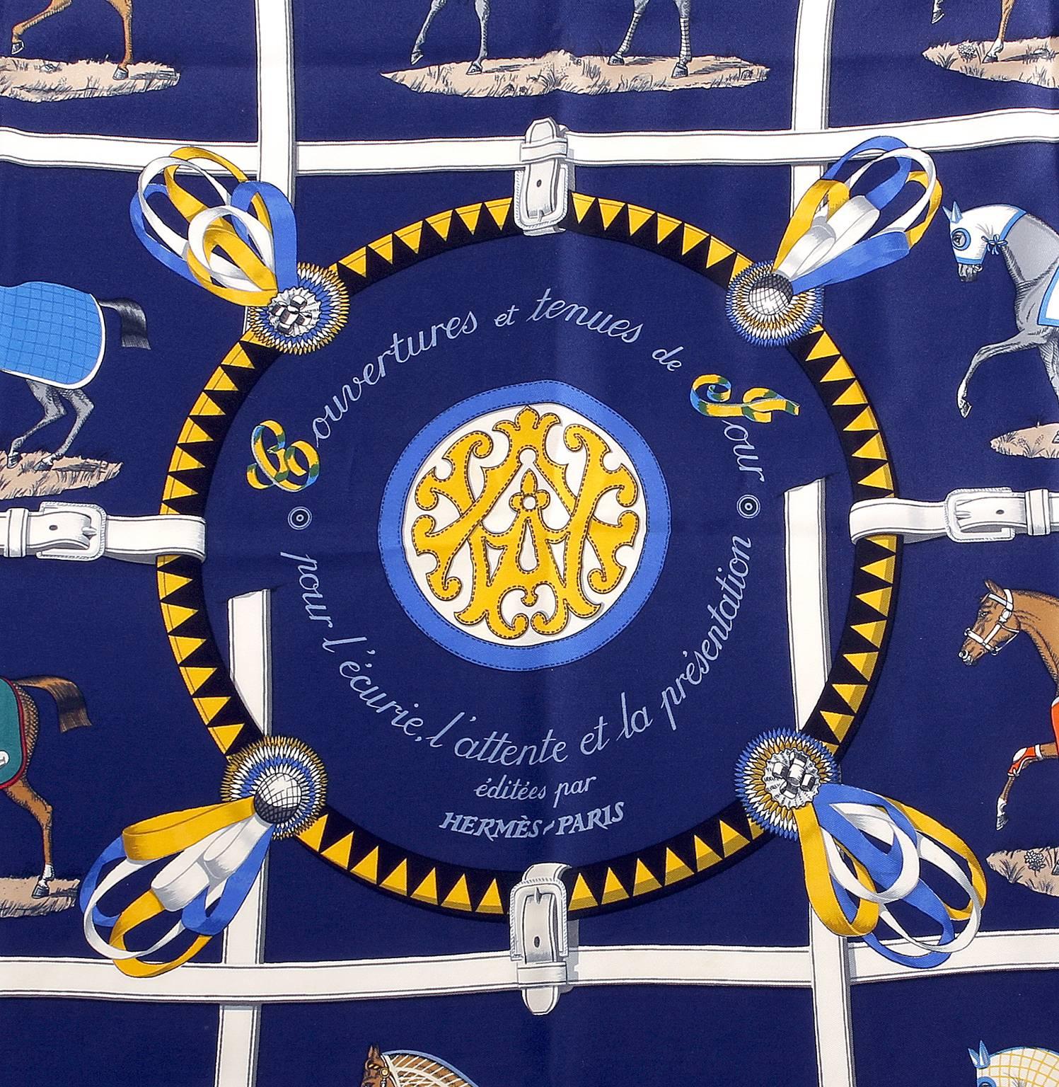 Hermès   Blue Couvertures et Tenues de Jour 90 cm Silk Scarf is in pristine condition.  The equestrian themed pattern features ten horses dressed in “blankets and day wear for the stable.”  100% silk, 90 cm.  Made in France.  Designed by Jacques