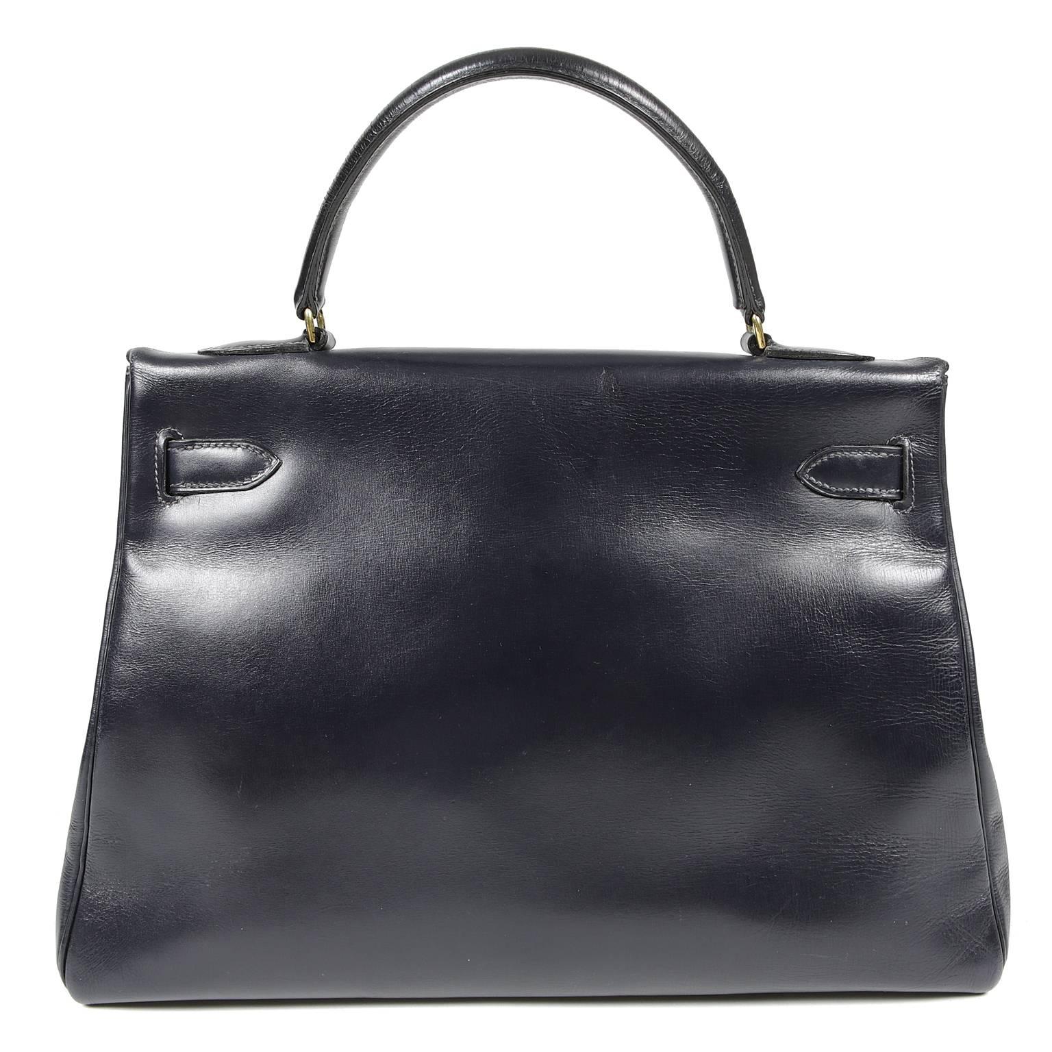 Hermès Navy Box Calf 32 cm Kelly Bag is in EXCELLENT vintage condition, a truly beautiful piece.  Crafted in one of the original Hermès leathers, it is a lovely find in a very desirable combination.  
 The ladylike Kelly is classic and refined,