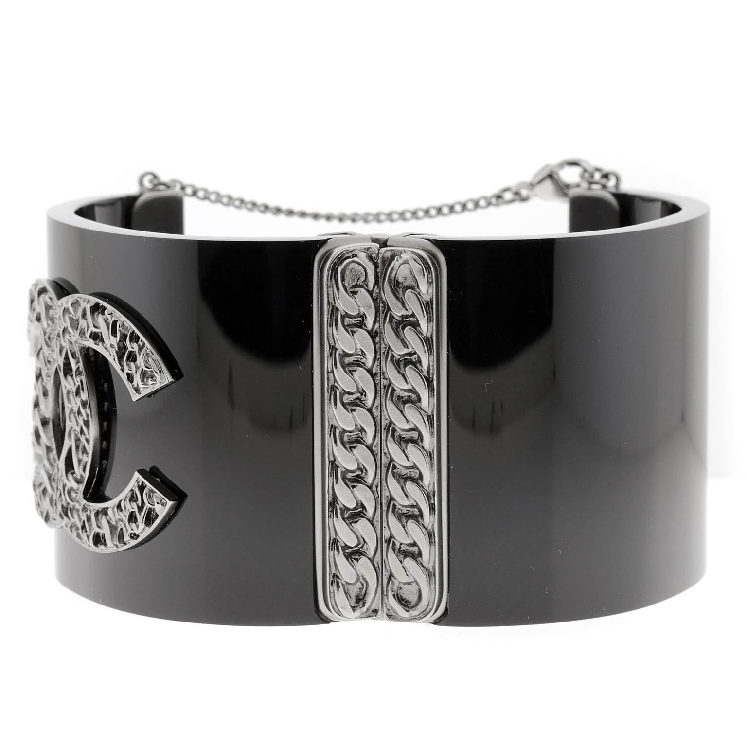  Chanel Black Resin Wide Cuff - Pristine and Unworn
 Edgy and classic at the same time, this piece is certain to become a wardrobe favorite with everything from jeans to gowns.  
Black resin hinged cuff with silver hardware.  Large interlocking CC