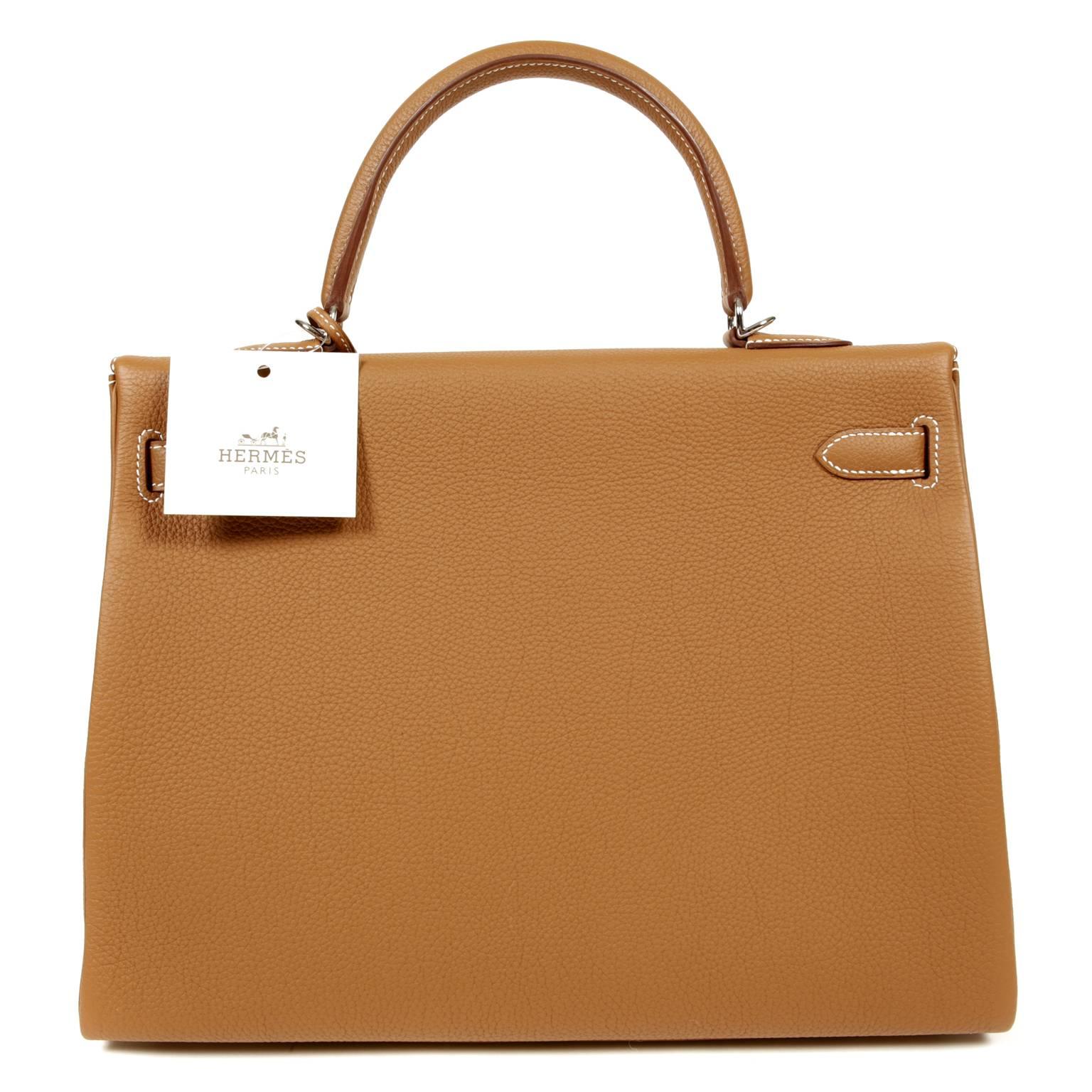 Hermès Gold Togo Leather 35 cm Kelly-  PRISTINE, Never Carried
The protective plastic is intact on all the hardware.    Considered the ultimate luxury item worldwide, each Hermès bag is handcrafted by skilled artisans.  Waitlists are often in