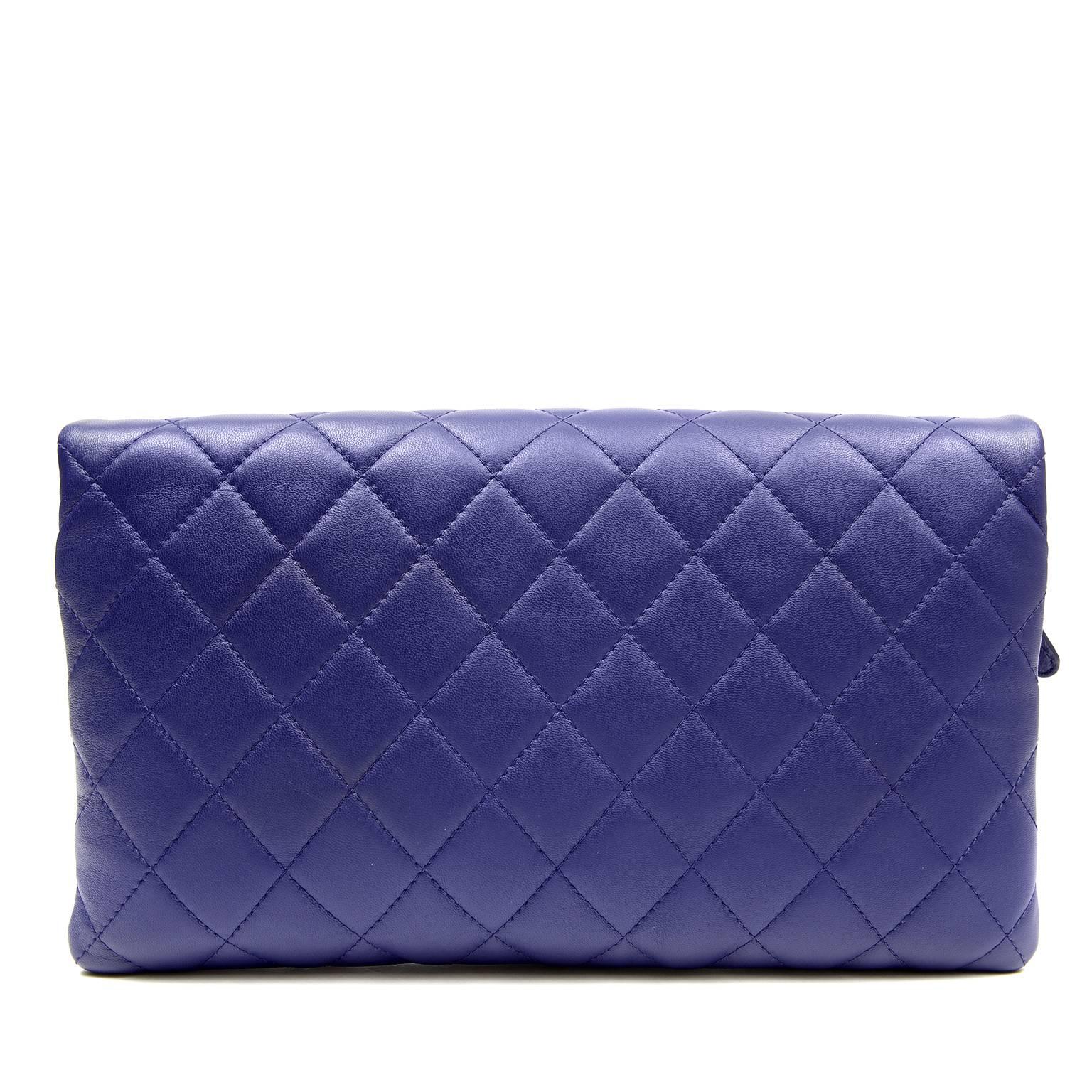 Chanel Purple Leather Clutch- PRISTINE, unworn condition.
 The fold over style features two separate zippered pouches that easily hold all the essentials for an evening out.
Regal purple leather is quilted in signature Chanel diamond stitched