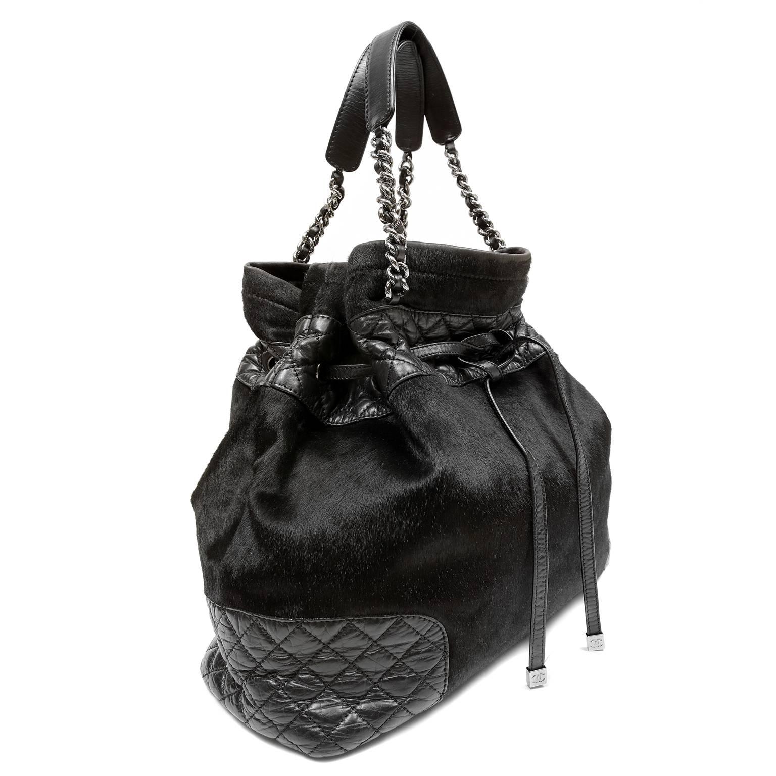 Chanel Black Calf Hair Drawstring Tote- PRISTINE Vintage Condition
  The combination of textures on this of- the- moment bucket style bag makes it a must have for collectors.  
Glossy black calf hair bucket style bag is accented with quilted