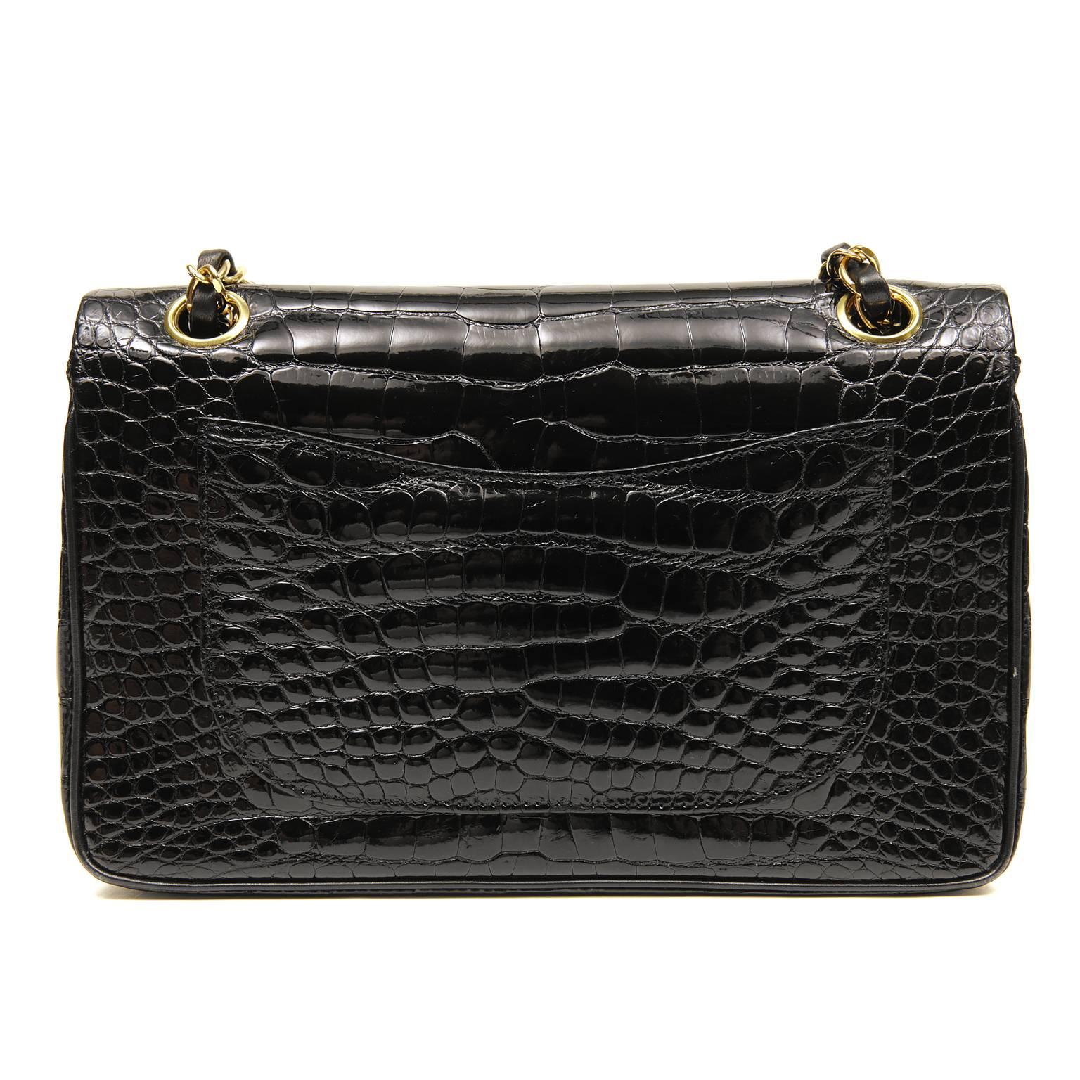 Chanel Black Crocodile Double Flap Classic- PRISTINE 
  Precious and rare, the exotics are a smart investment certain to hold their value. 
 
Glossy black Porosus Crocodile skin is accented with gold tone hardware.  An interlocking CC twist lock
