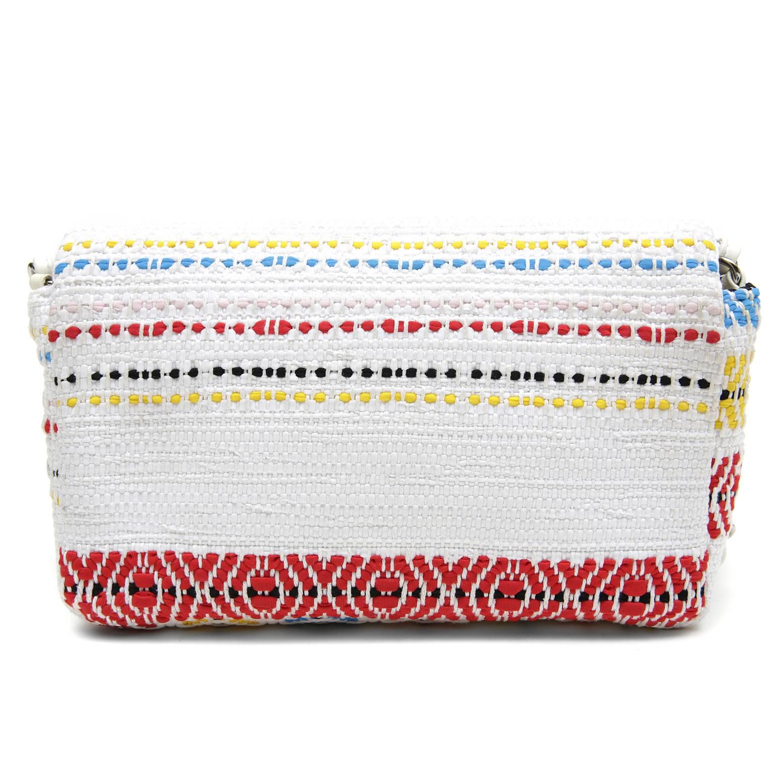Chanel White Multicolor Woven Flap Bag - EXCELLENT PLUS
 Uniquely patterned in a soft tribal print with happy colors, this charming Chanel is a must have on any holiday or summer getaway.  
White woven fabric is striped in shades of bright blue,
