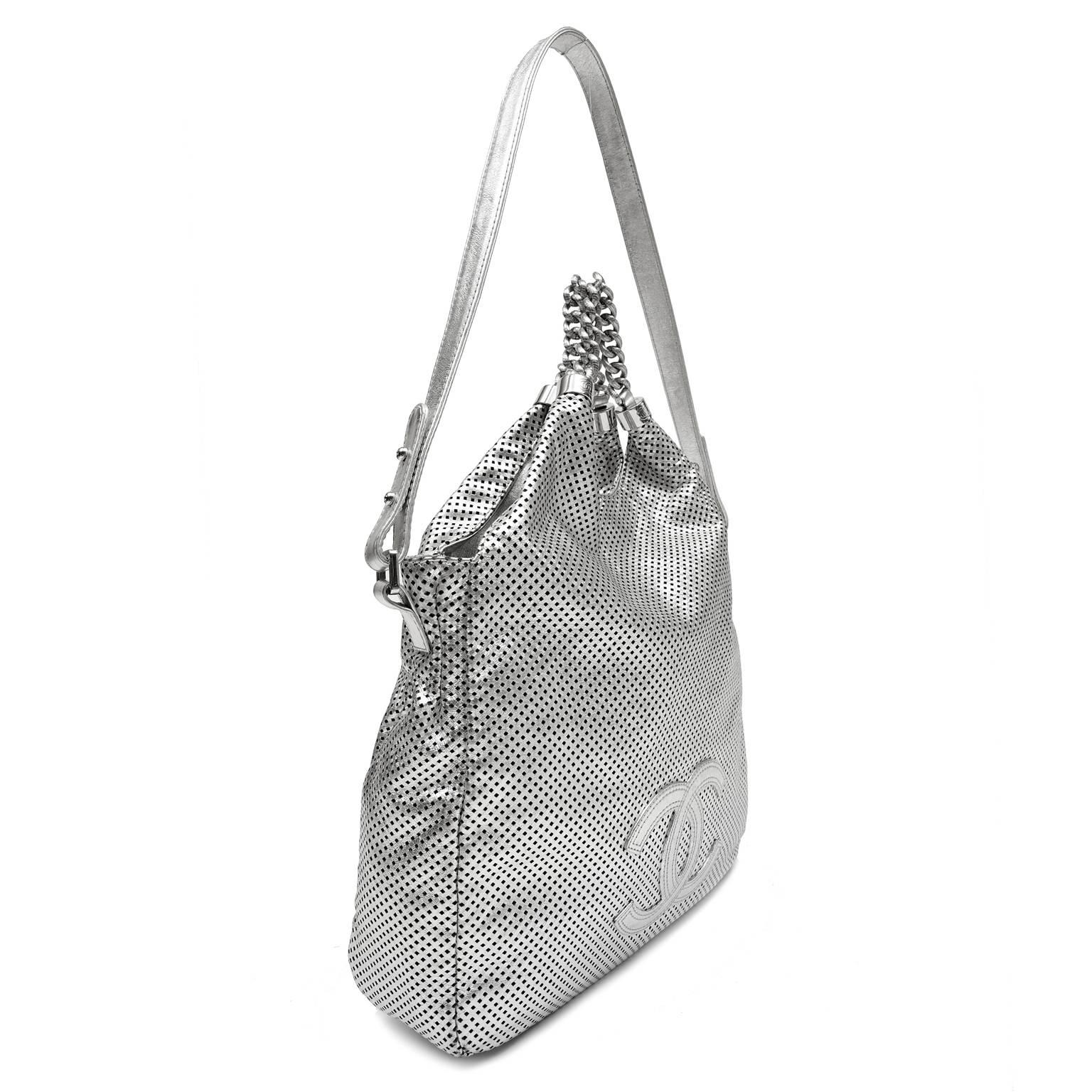 Chanel Metallic Silver Leather Rodeo Drive Hobo- EXCELLENT PLUS 
  A casual every day bag with a carefree vibe, it is a must have for warm weather vacations and summer holidays.  
Metallic silver leather hobo is perforated throughout and accented