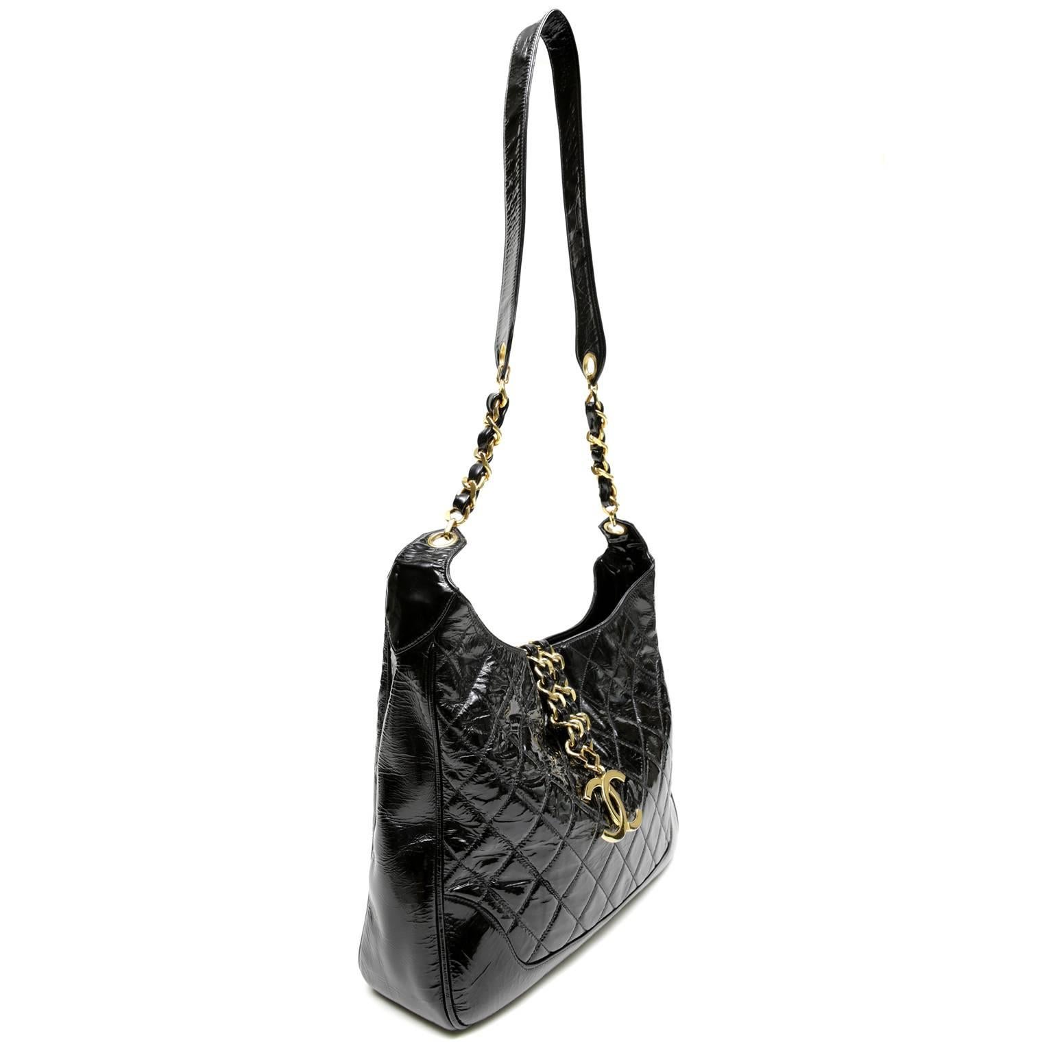 Chanel Vintage Black Patent Leather Cross Body Bag- Nearly Pristine Condition
  An 18K gold plated oversized CC makes this extraordinary piece truly collectible.  
Sleek black patent leather is quilted in signature Chanel diamond stitched pattern.