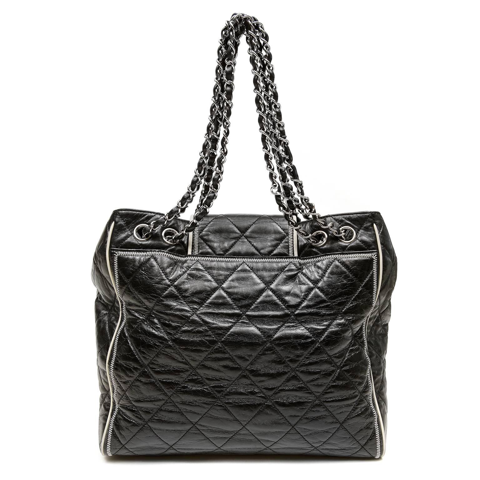 Chanel Black Mademoiselle Flap Tote- PRISTINE
 Cream leather piping and zigzag stitching bring striking contrast to this edgy daily carryall.
Black leather north south tote is quilted in signature Chanel diamond pattern.  Cream leather piping and