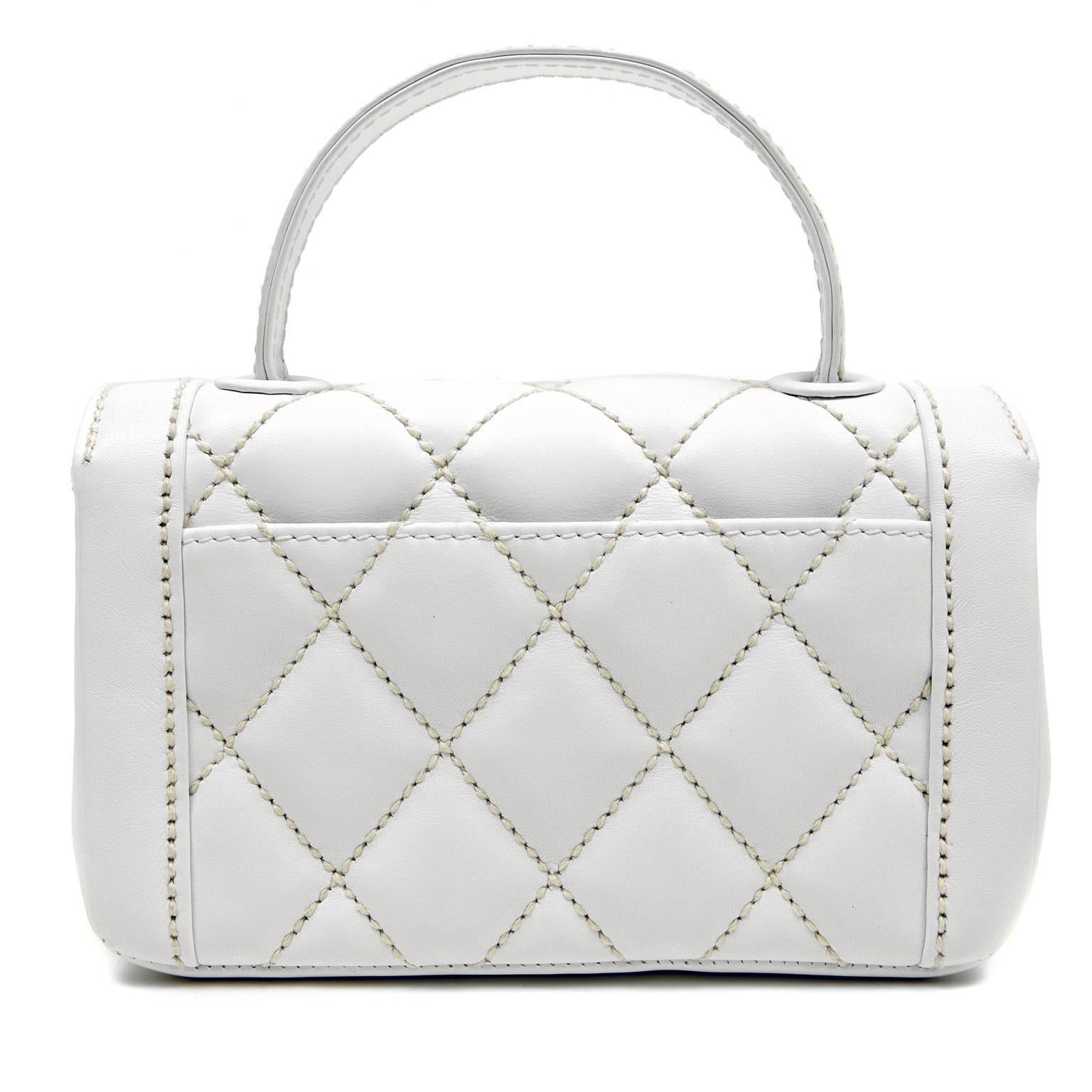 Chanel White Leather Mini Kelly Classic -PRISTINE
 Petite and demure, this piece epitomizes the ultimate Chanel for luncheons and a day of shopping.

White leather is top stitched with creamy contrasting diamond stitching.  Gold tone interlocking
