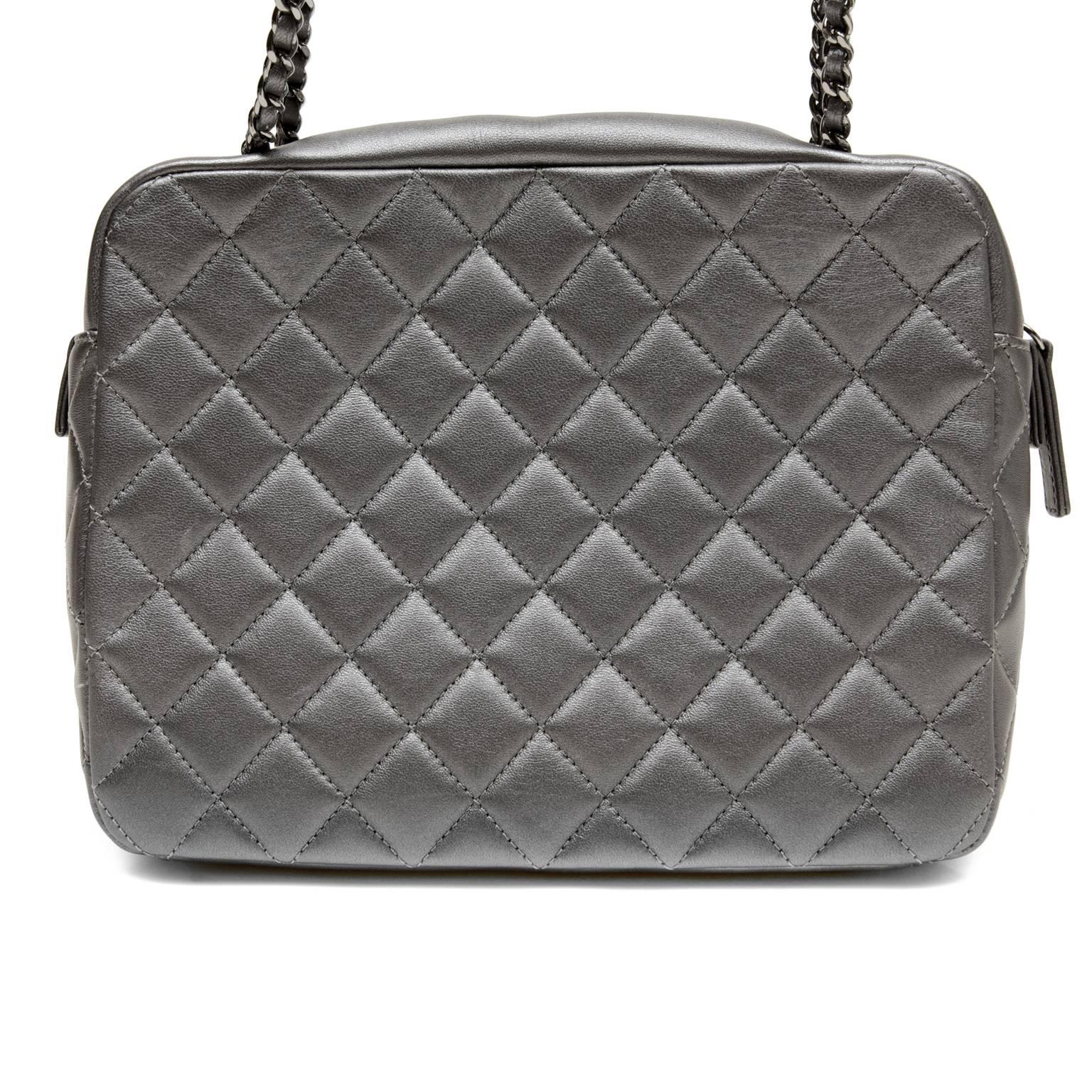 Chanel Evening Art Flap Bag- PRISTINE
Runway Spring 2014 collection  
 Very unique, the camera case style may be carried cross body or on the shoulder and works with nearly every color.  
Dark metallic pewter leather is quilted in signature