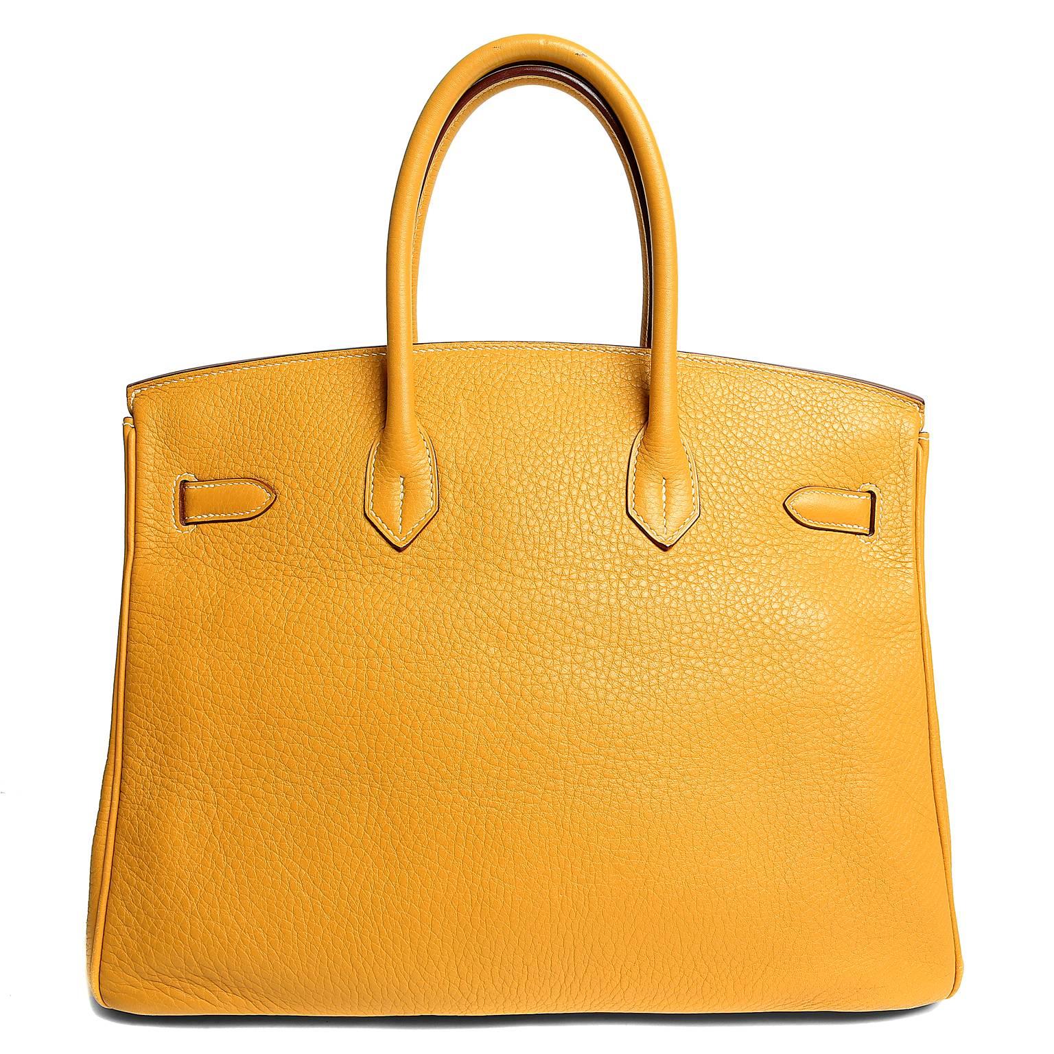 Hermès Moutarde Clemence 35 cm Birkin- PRISTINE
 Hermès bags are considered the ultimate luxury item the world over.  Hand stitched by skilled craftsmen, wait lists of a year or more are commonplace.  Moutarde is a lovely golden yellow with warm
