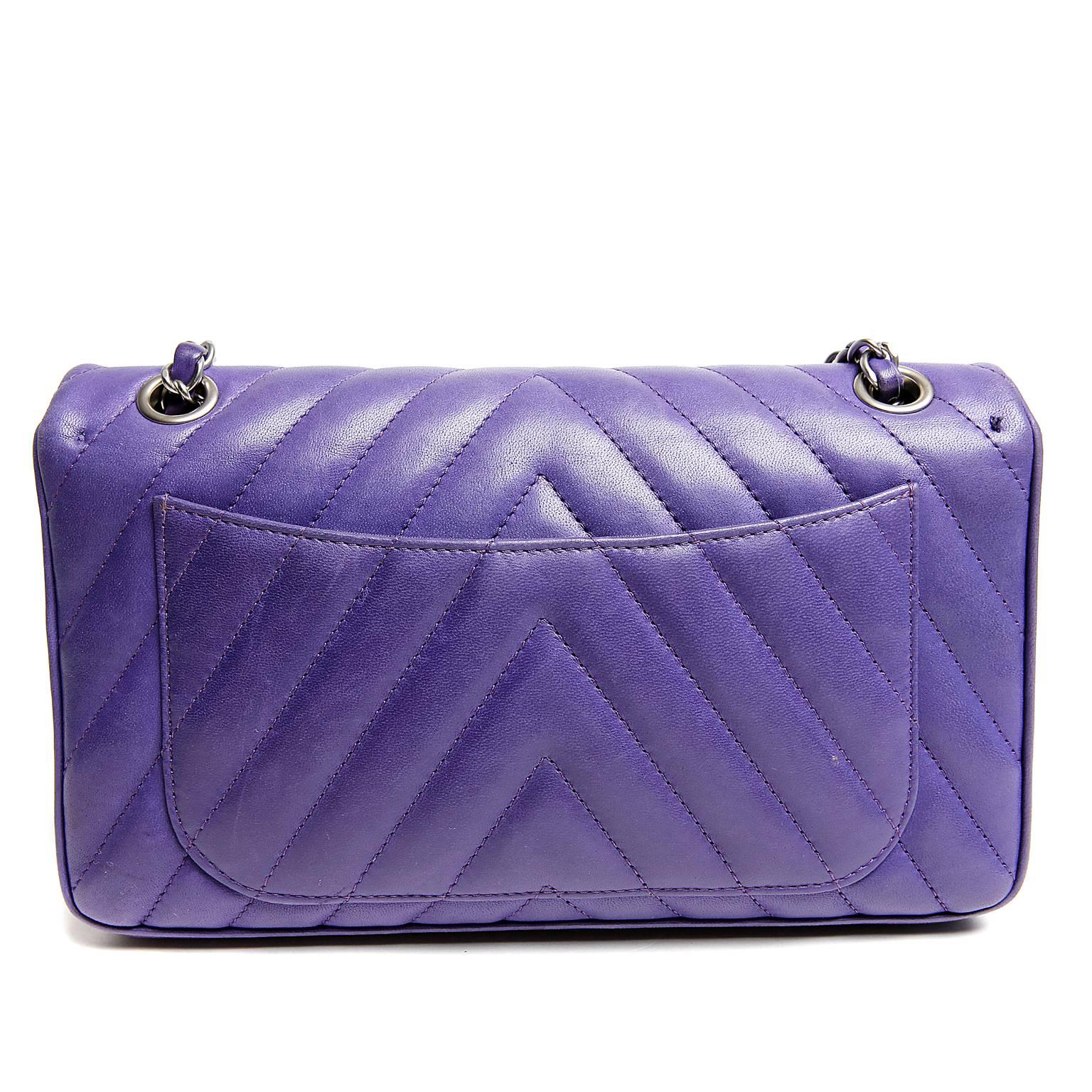 Chanel Purple Chevron Lambskin Leo Flap Bag- PRISTINE
.  In the medium silhouette, this collectible Chanel can be worn in any circumstance.
 
Brilliant purple lambskin is quilted in chevron pattern.  Brushed silver twist lock is surrounded by a