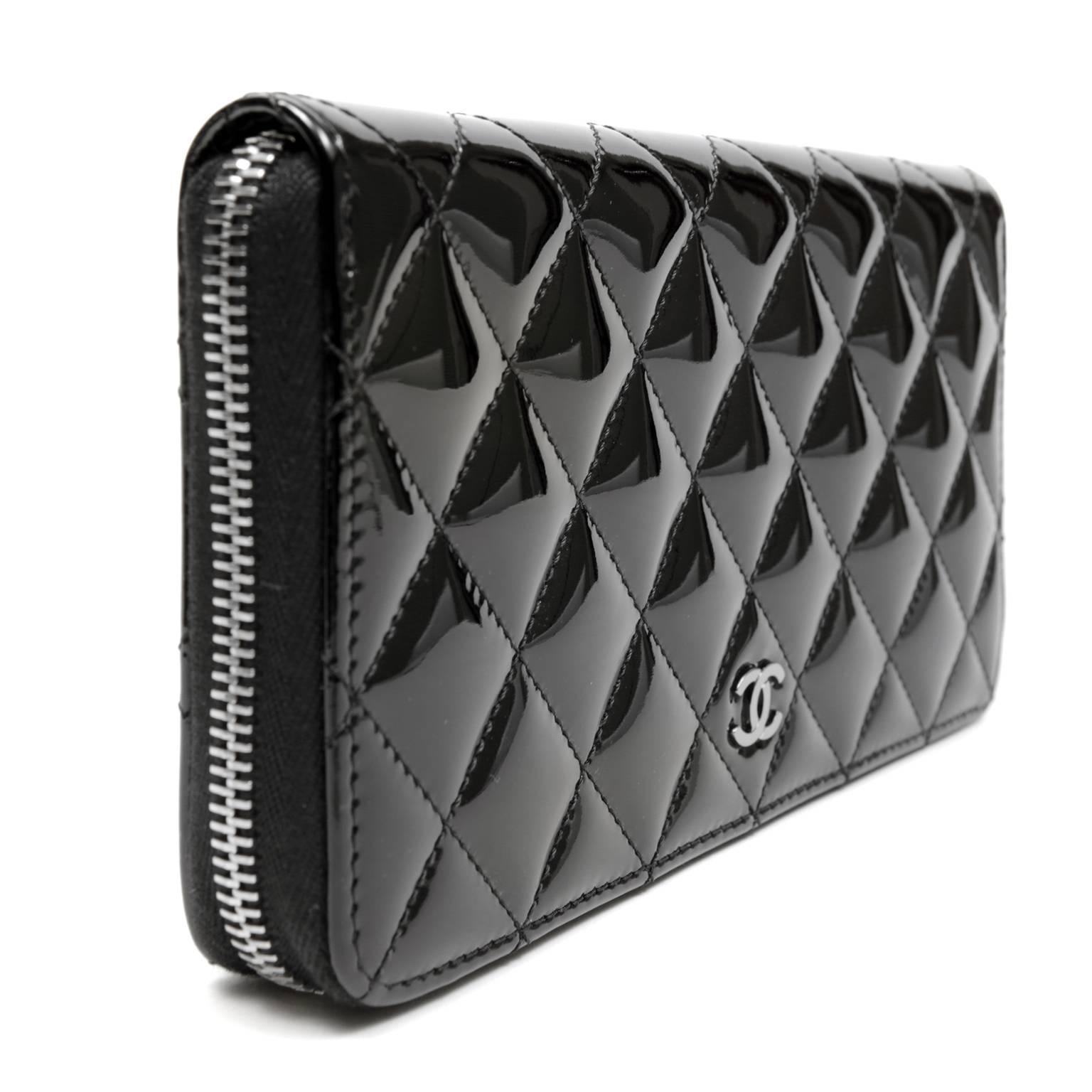 Chanel Black Patent Leather Zip Around Wallet- PRISTINE; Never Carried
Quilted patent leather is ultra-durable, perfect for an often handled accessory. 
 
Large quilted black patent leather wallet has silver zipper on three sides.  Gusseted sides