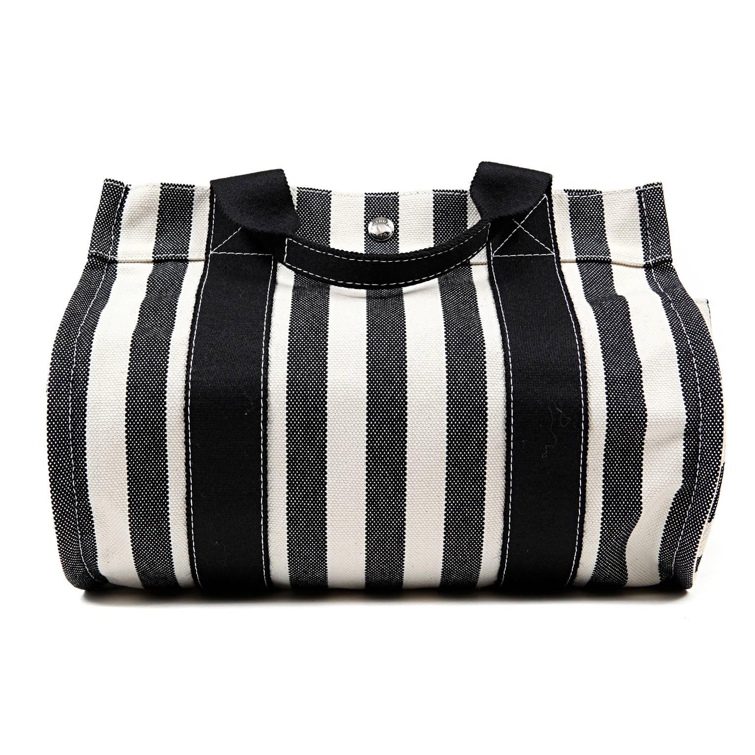 Hermès Black and White Striped Canvas Tote- PRISTINE
  The cheerful summertime carryall is accompanied by a coordinating black canvas case.
 
Black and cream striped canvas tote is carried in hand or at the elbow by double handles.  Rounded