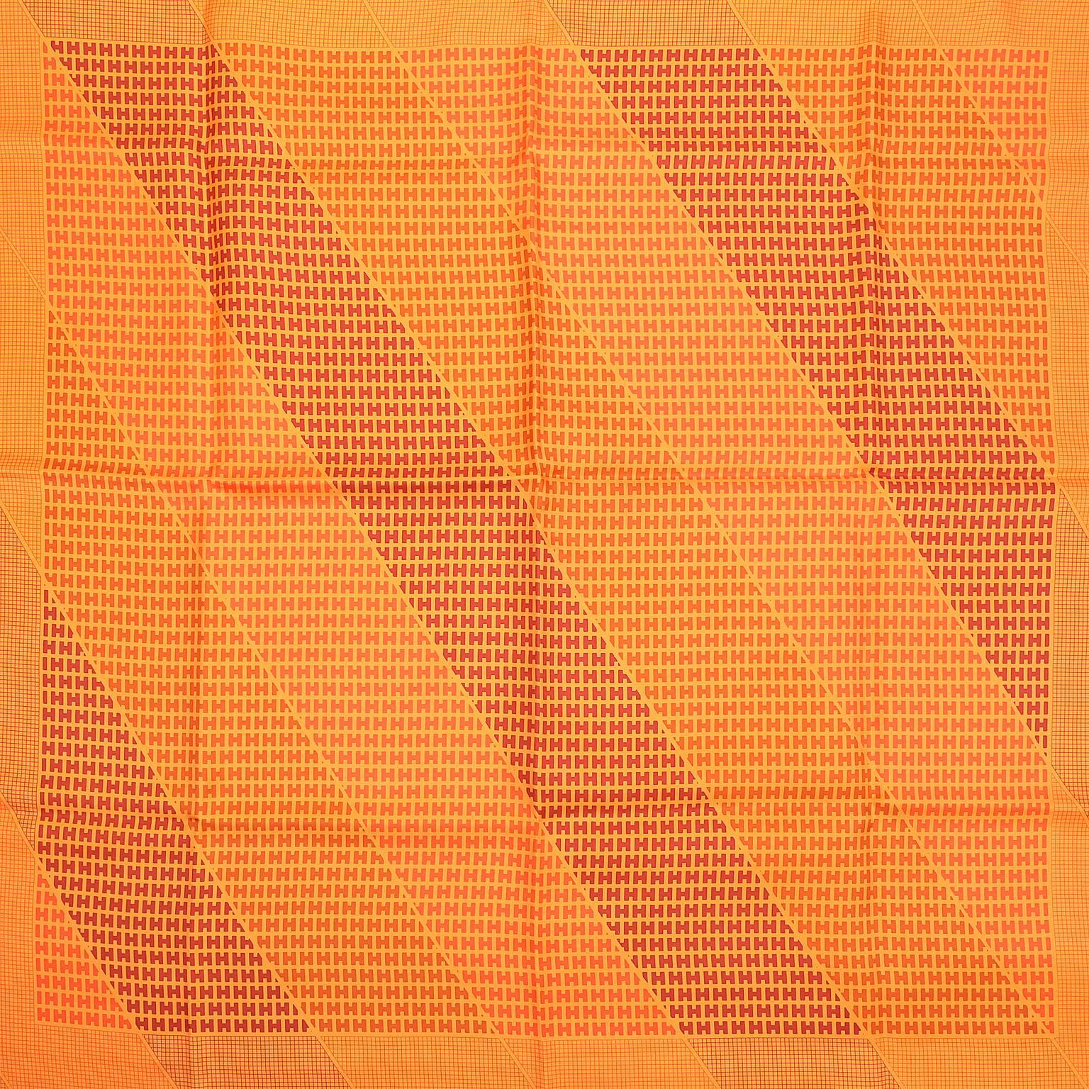 Hermès Orange Silk H Scarf- PRISTINE
.  The graphic pattern features capital H letters in varying shades of orange arranged in a diagonal design. Orange background.  100% silk.      Made in France.  