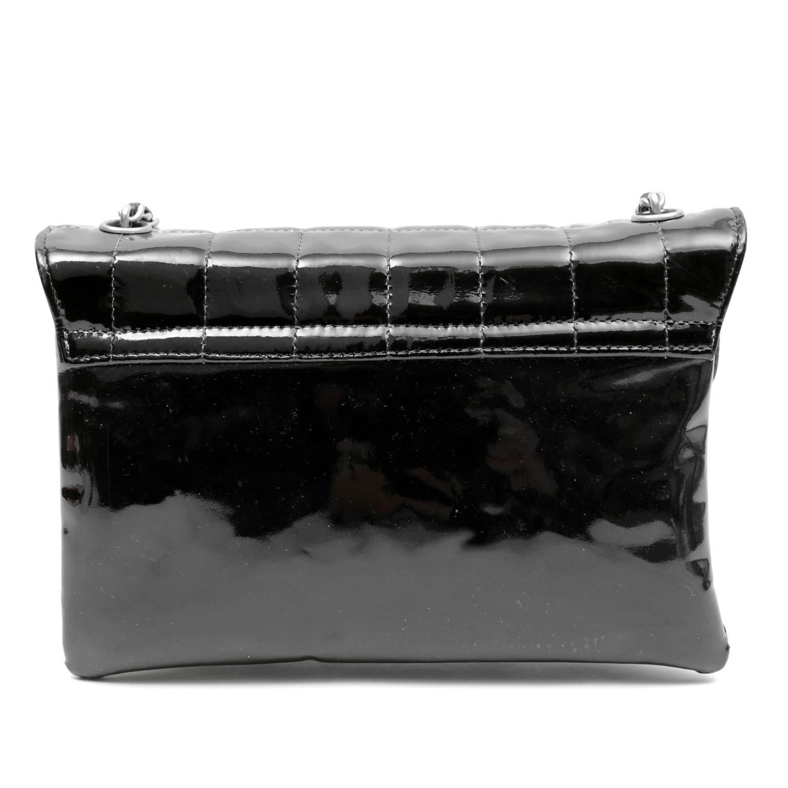 Chanel Black Patent Leather Keyboard Flap Bag- Pristine
  A whimsical closure makes this unique piece a fun addition to any collection.  

Black patent leather is stitched in square quilted pattern.  Black computer keys spell out CHANEL and